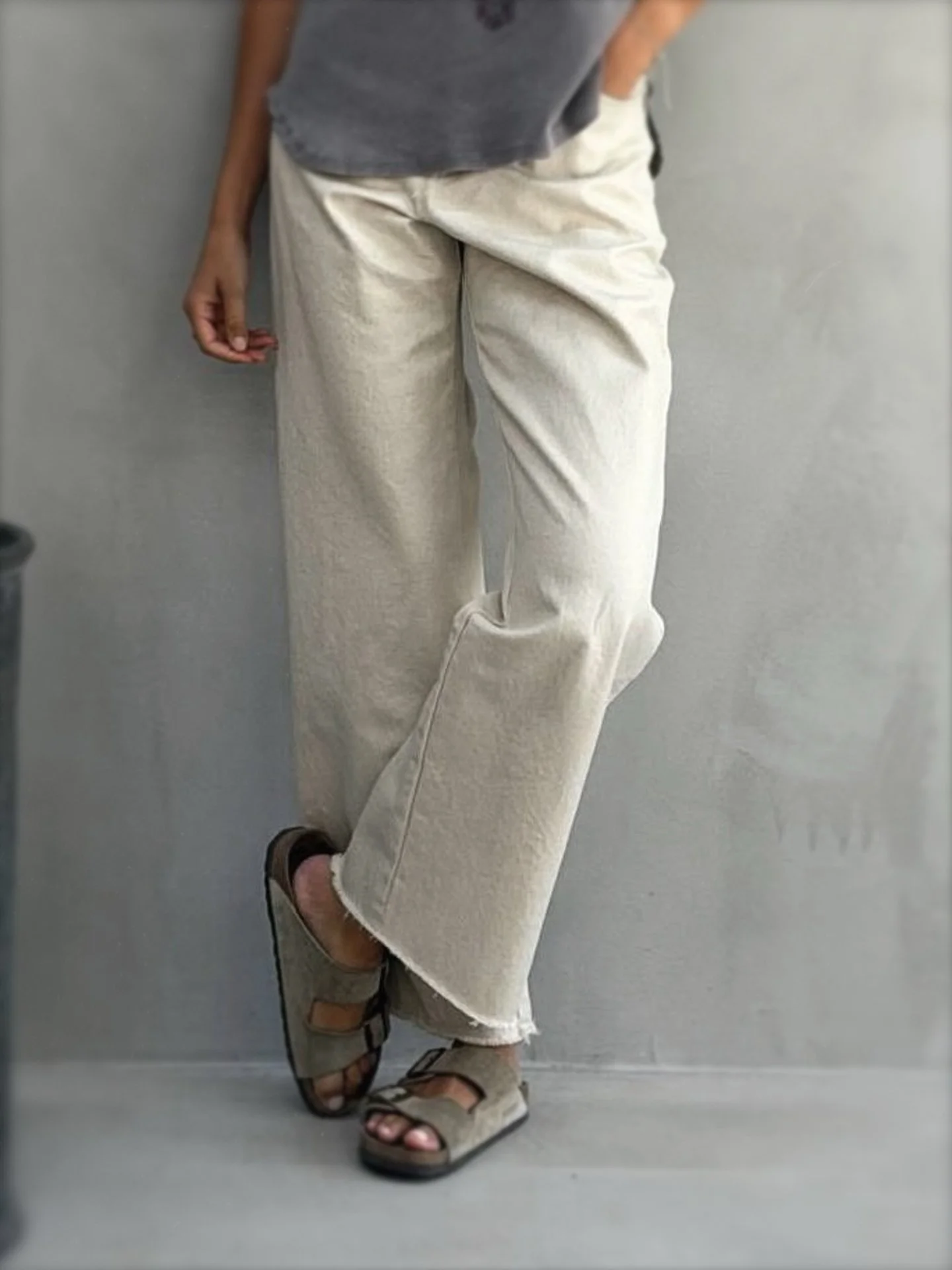 Woman wearing beige Banditas Shimmer Wide-Leg Pants with relaxed fit and raw ankle-length hems