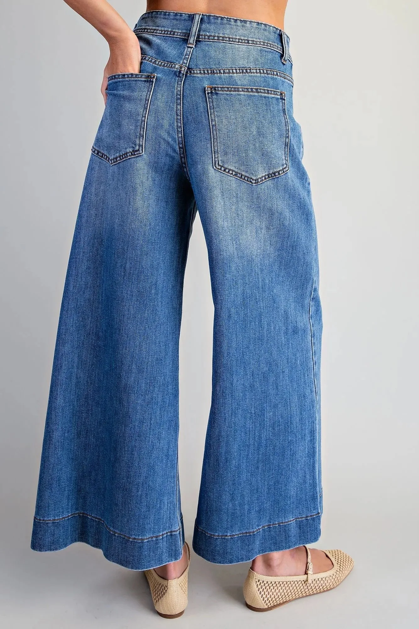 Blue wide leg crop jeans showing front pockets and cropped silhouette