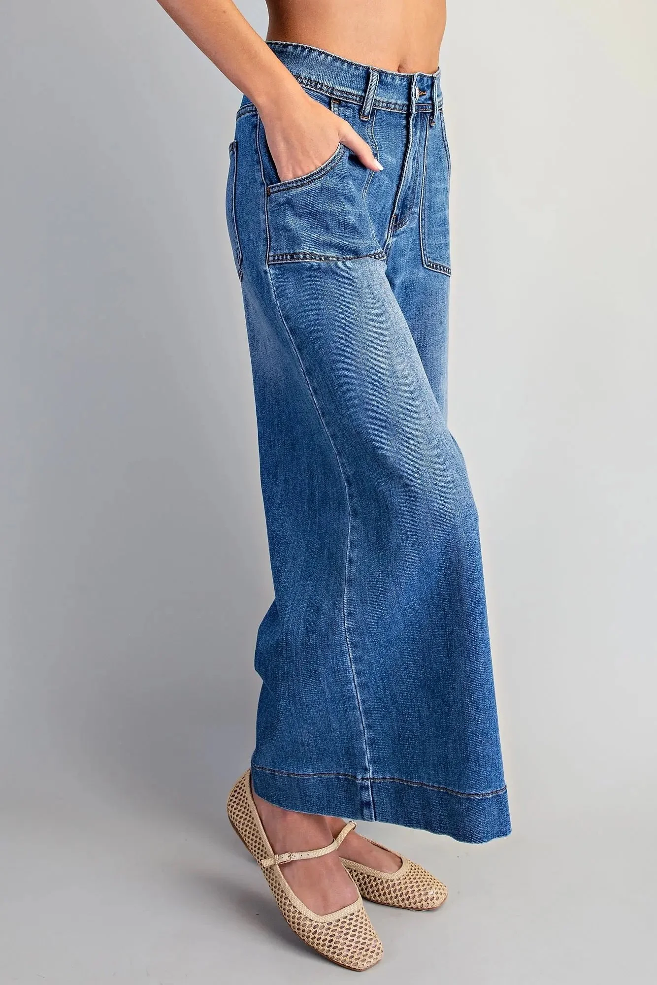 Blue wide leg crop jeans shown from the side