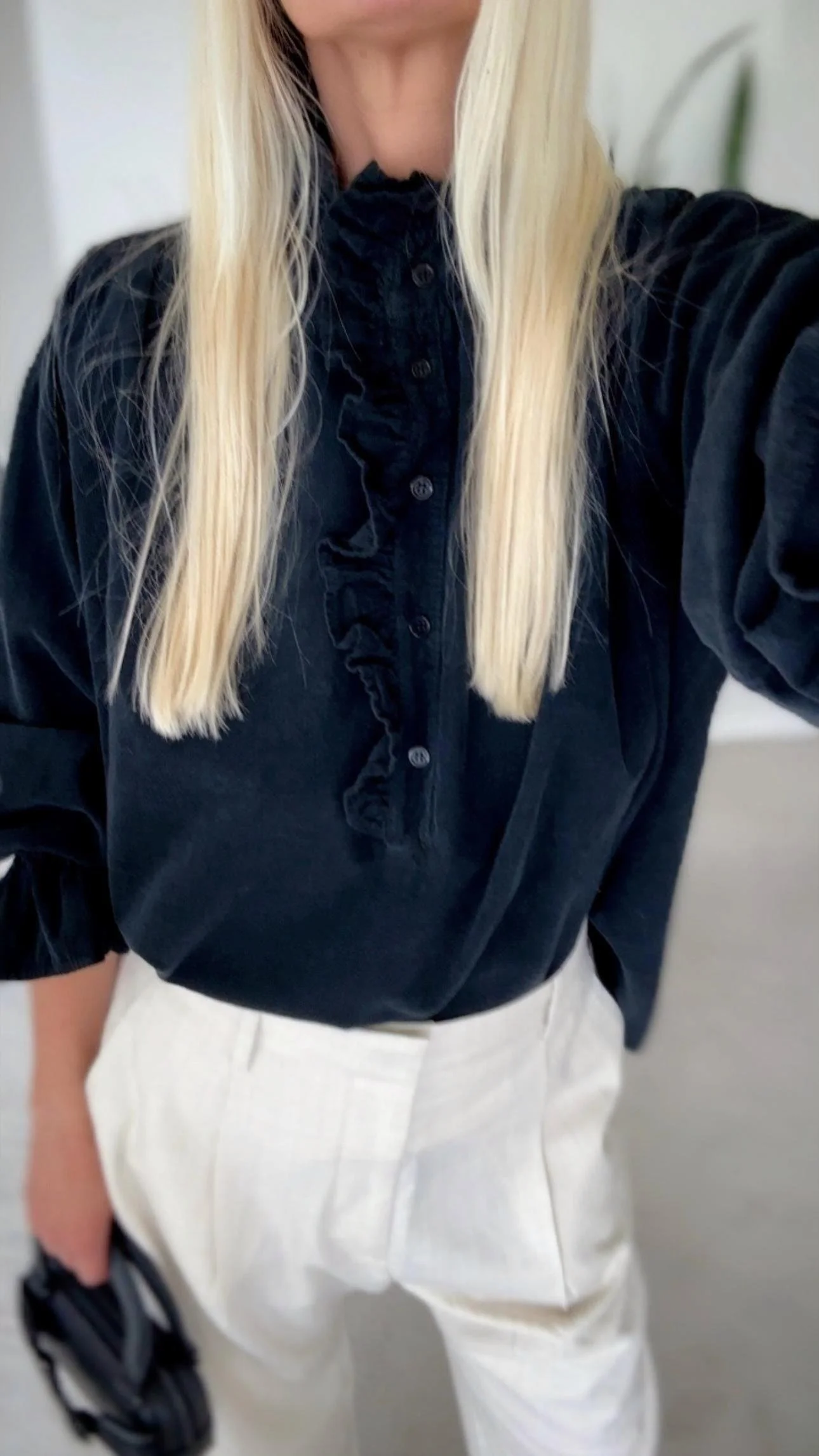 Lightweight black fine corduroy blouse with softly gathered ruffles.