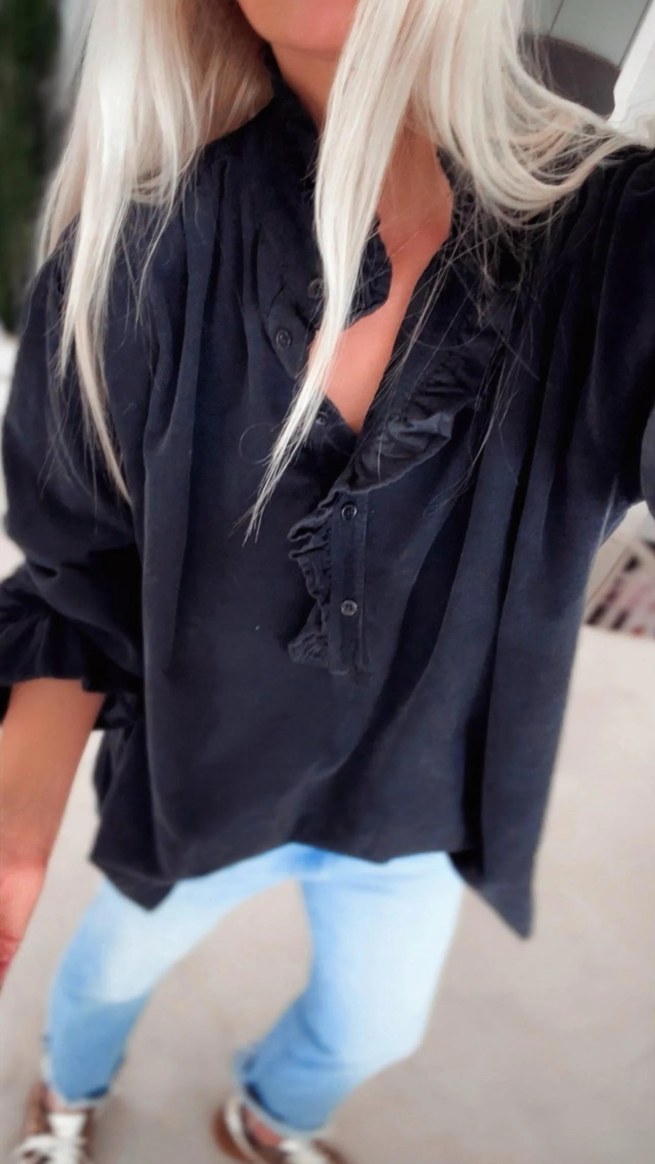 Front view of the black corduroy ruffle blouse from Coastal Thread.
