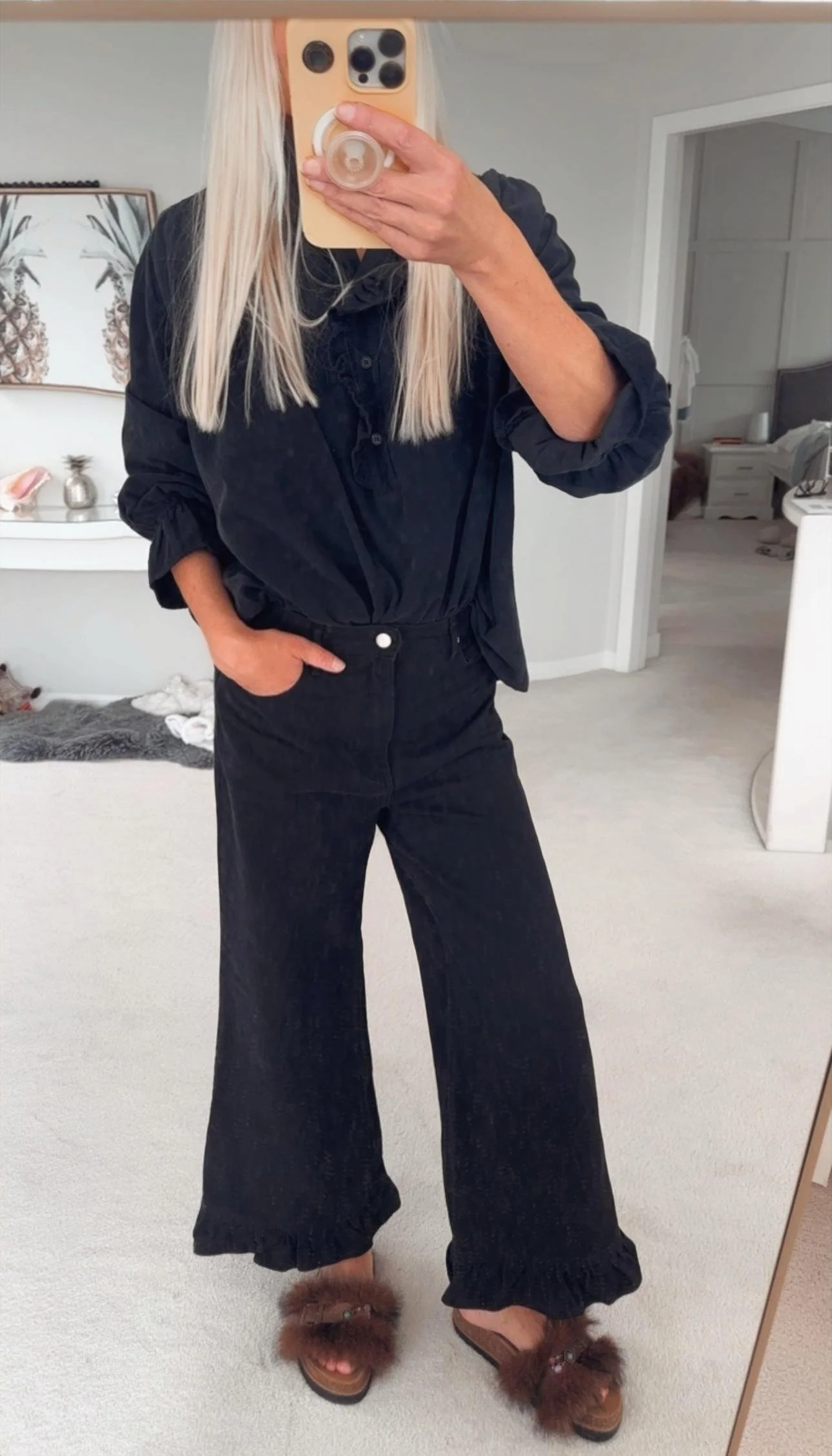 Black corduroy ruffle blouse styled for an effortless everyday look.
