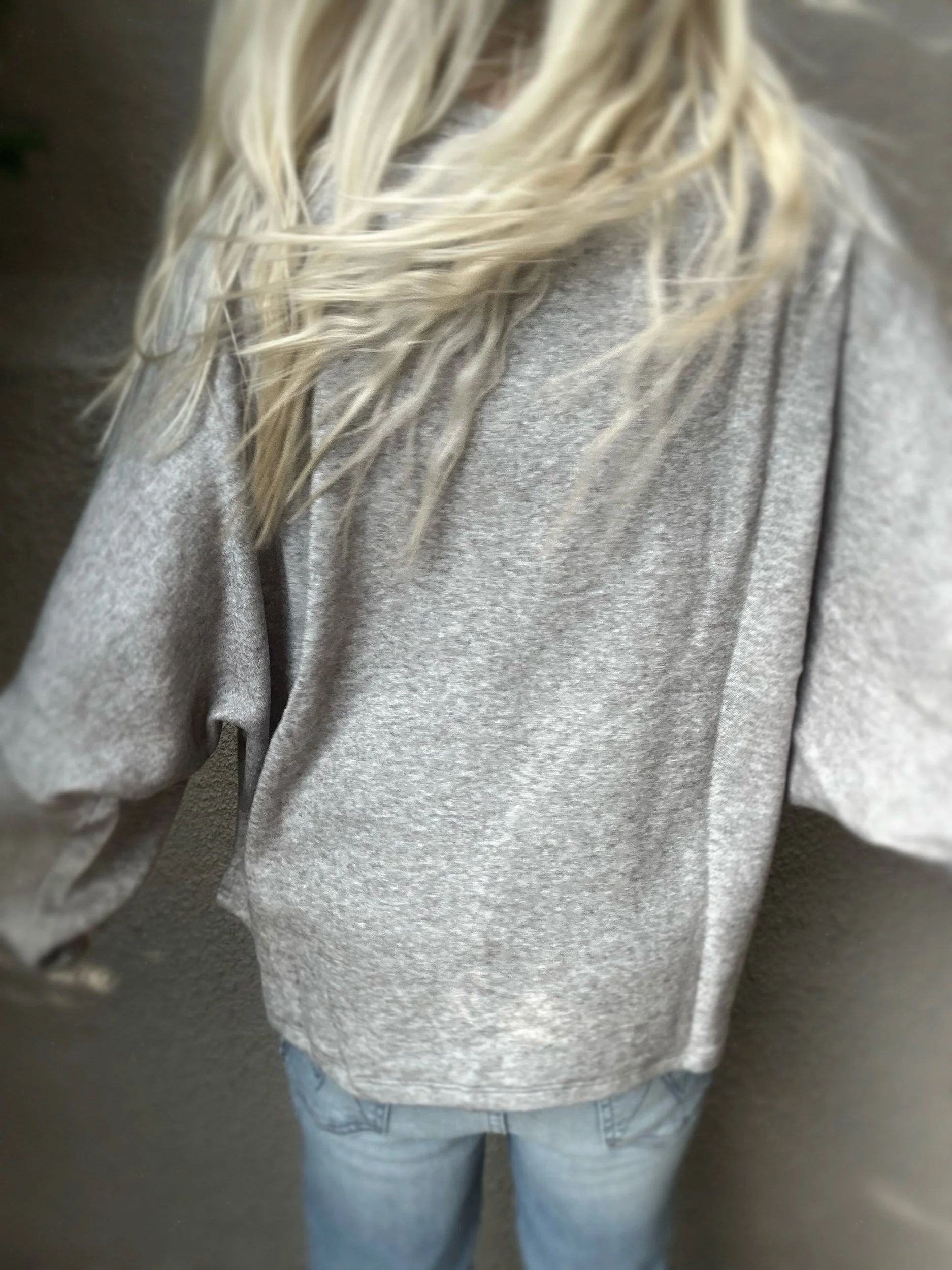 Back view of grey Banditas Haiku Sweatshirt showing its relaxed oversized shape