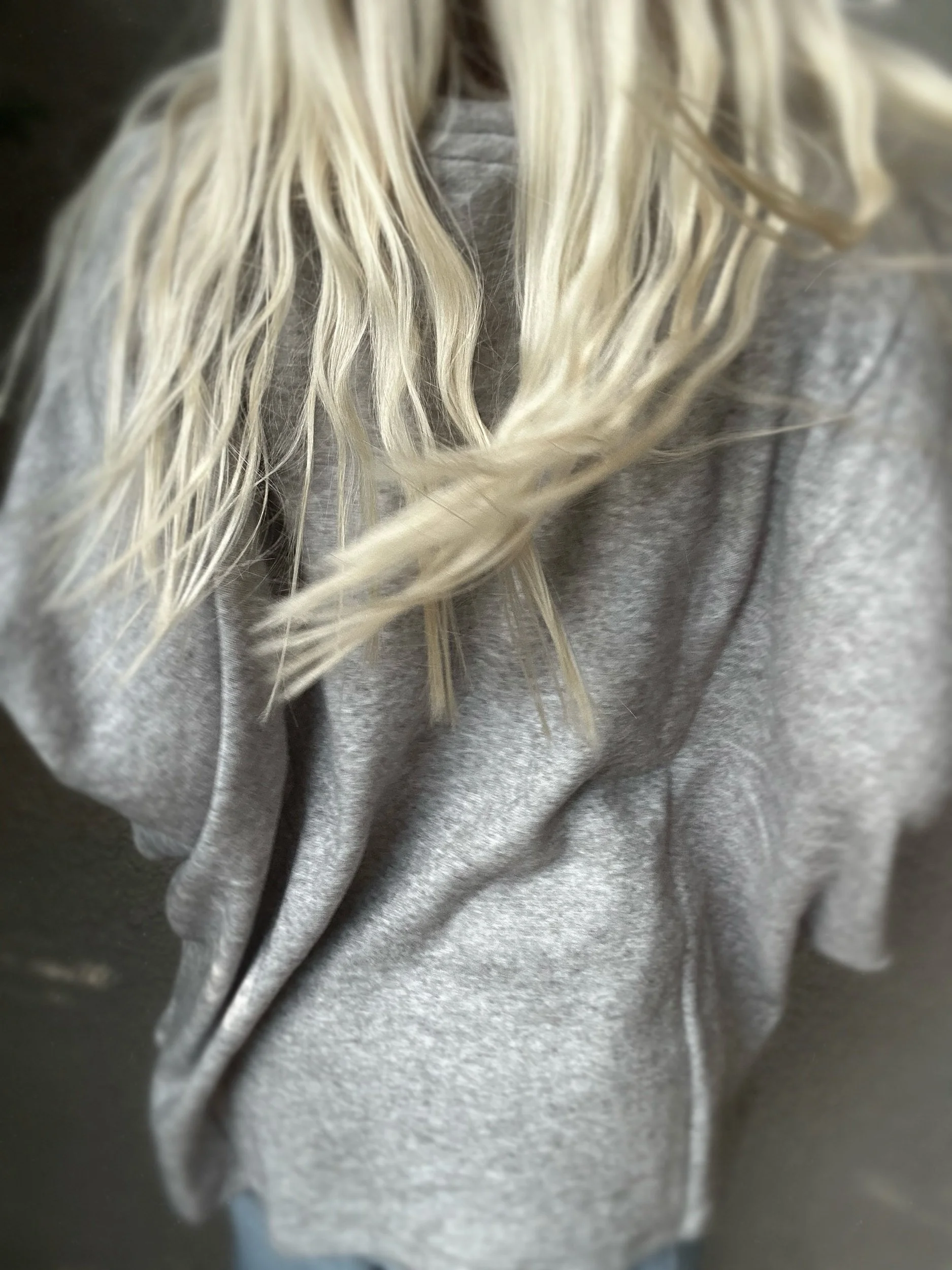 Back detail of grey Banditas Haiku Sweatshirt showing its loose drape and textured fabric