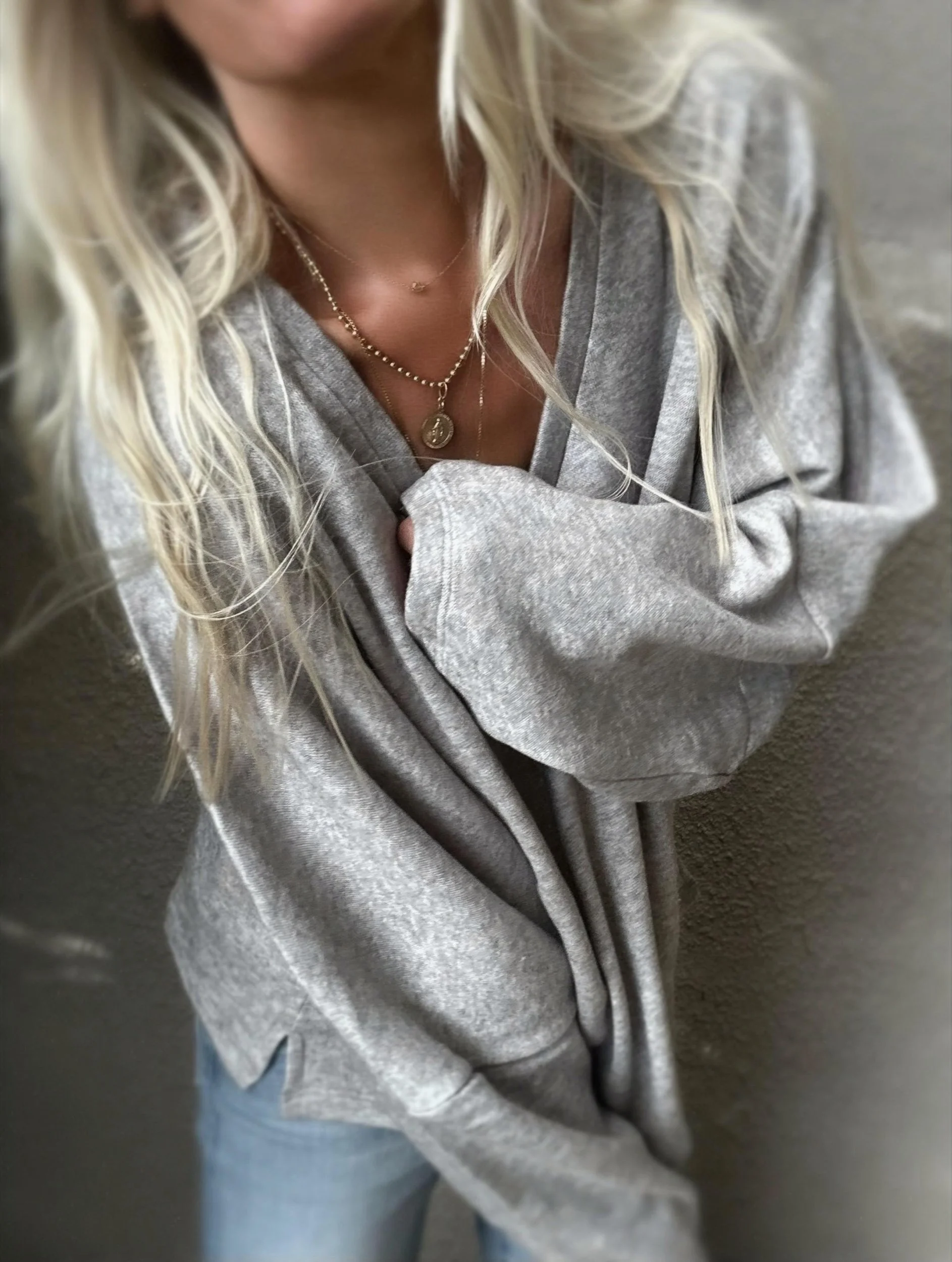 Woman wearing the grey Banditas Haiku Sweatshirt with V-neckline and relaxed batwing sleeves