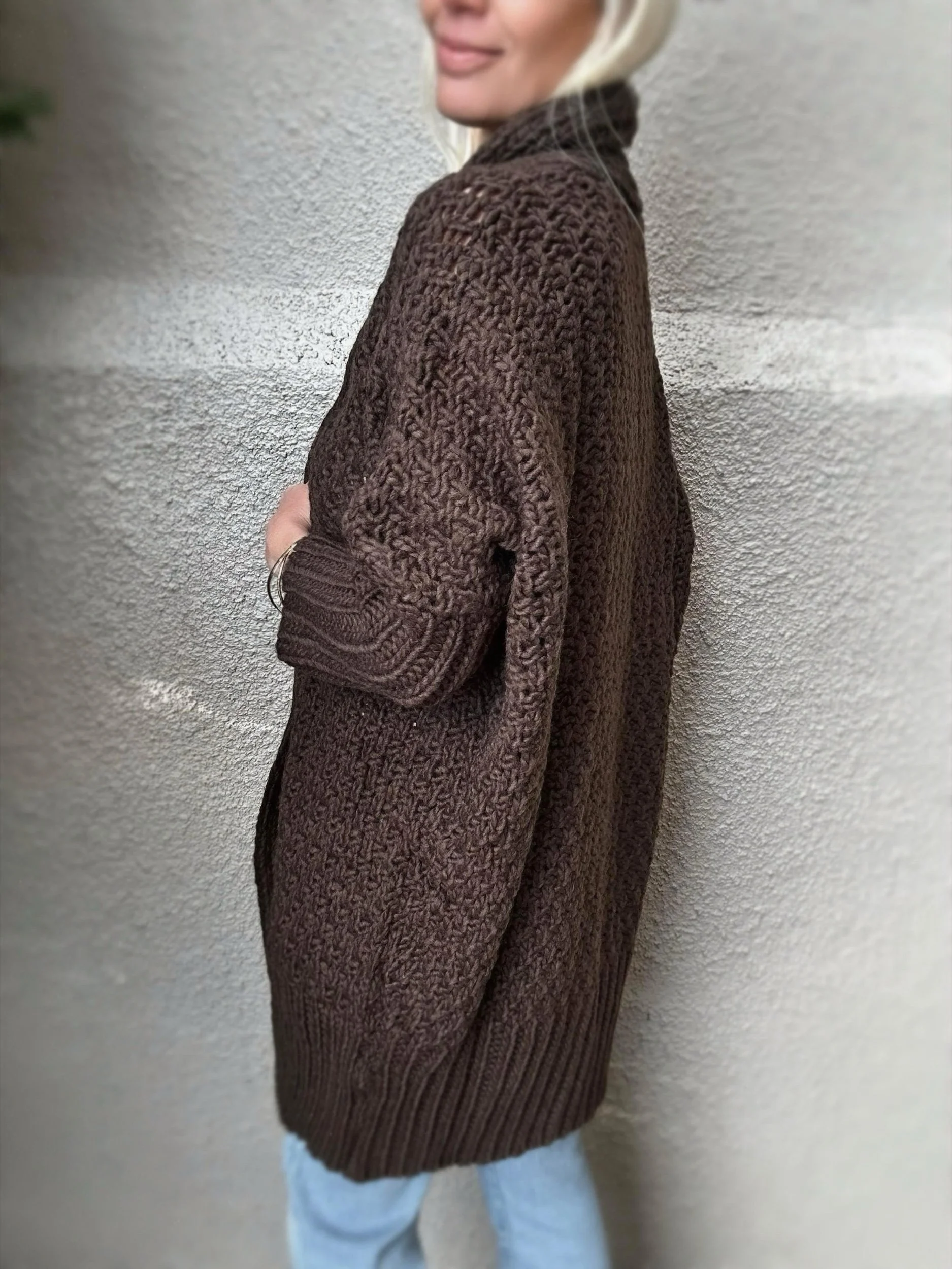 Side view of brown Banditas Honolua Long Cardigan showing its long, loose silhouette