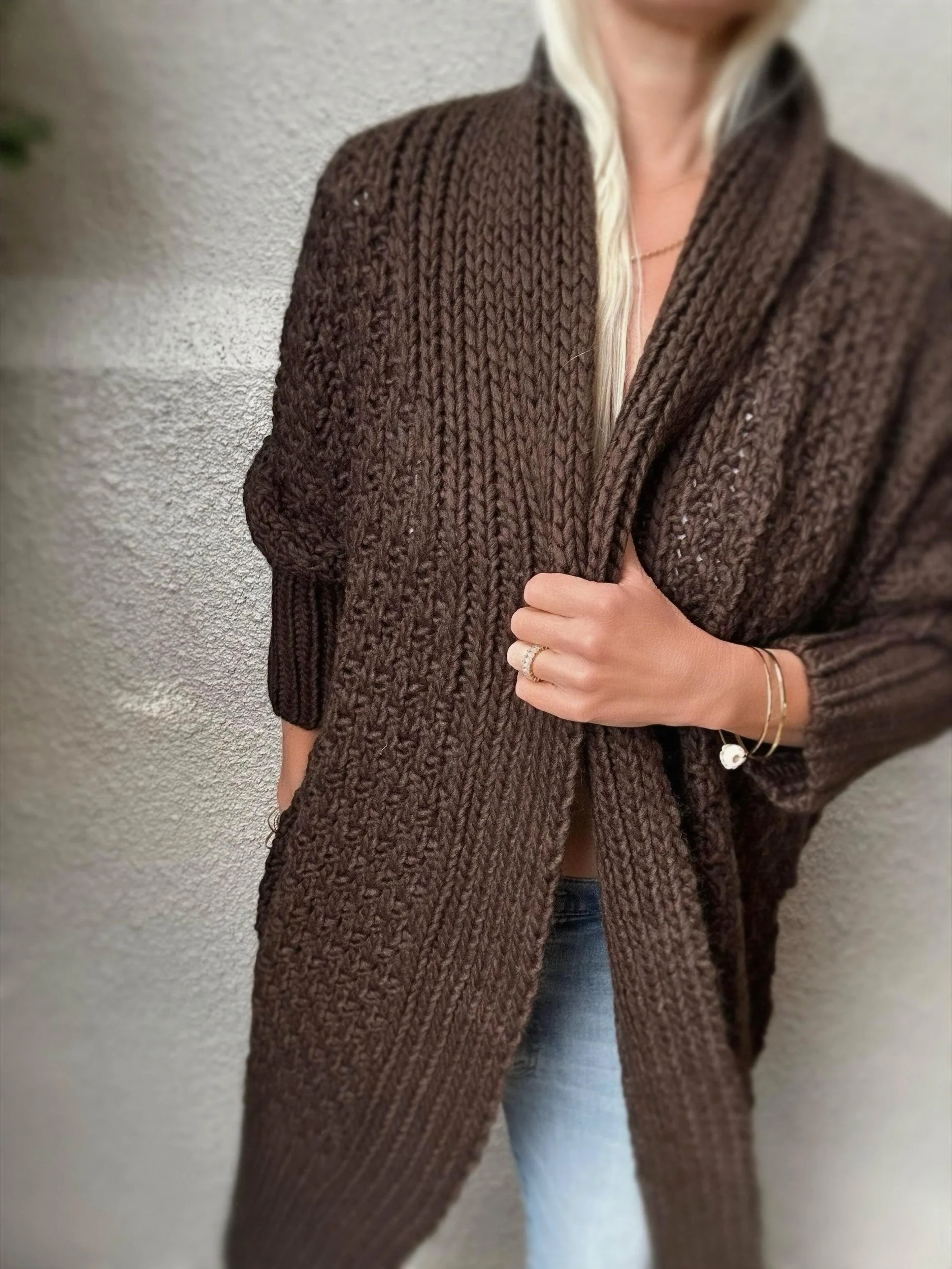 Woman wearing the brown Banditas Honolua Long Cardigan with chunky knit texture and relaxed oversized fit