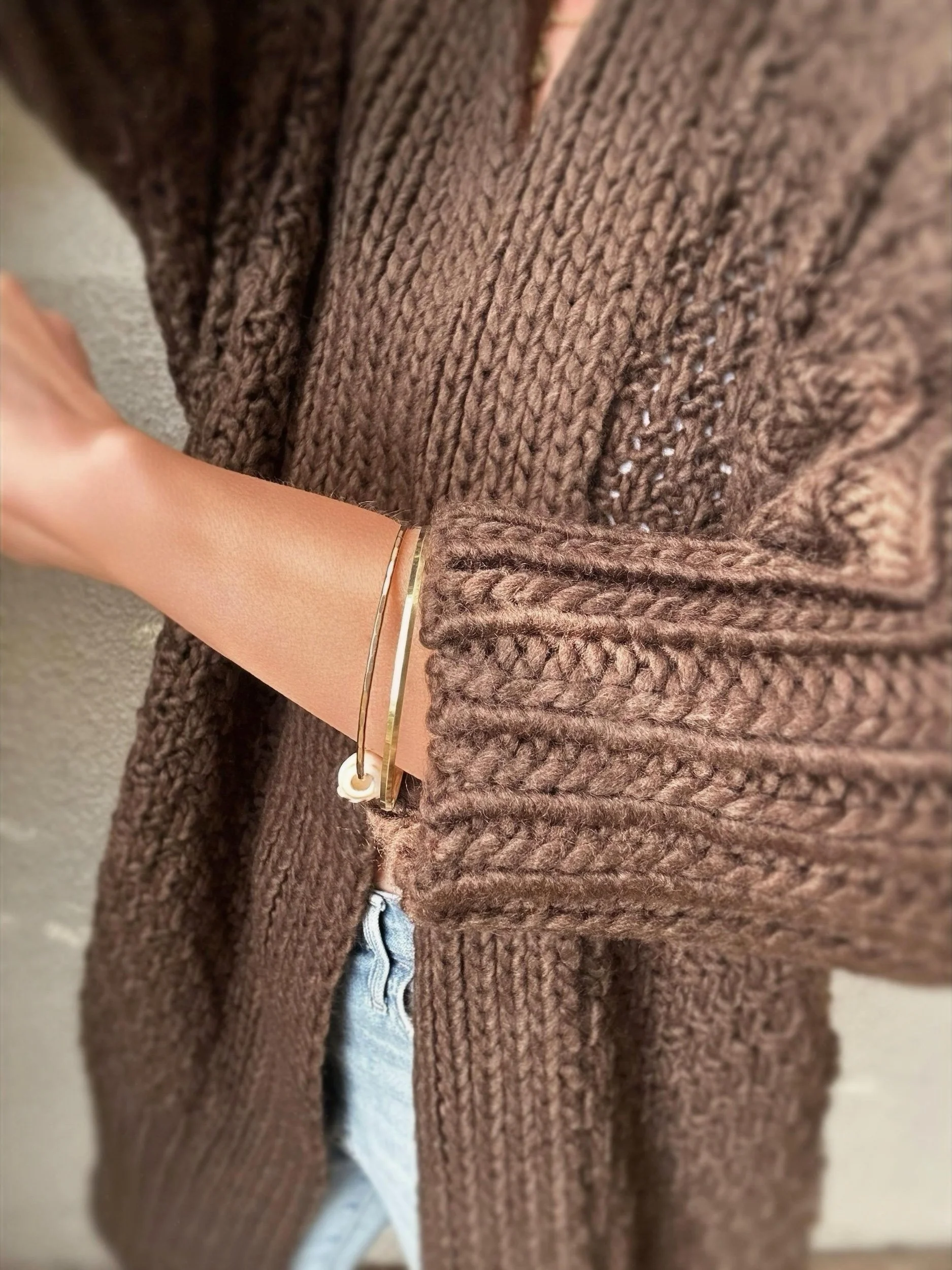 Close-up of brown Banditas Honolua Long Cardigan showing its textured knit and ribbed sleeve cuff