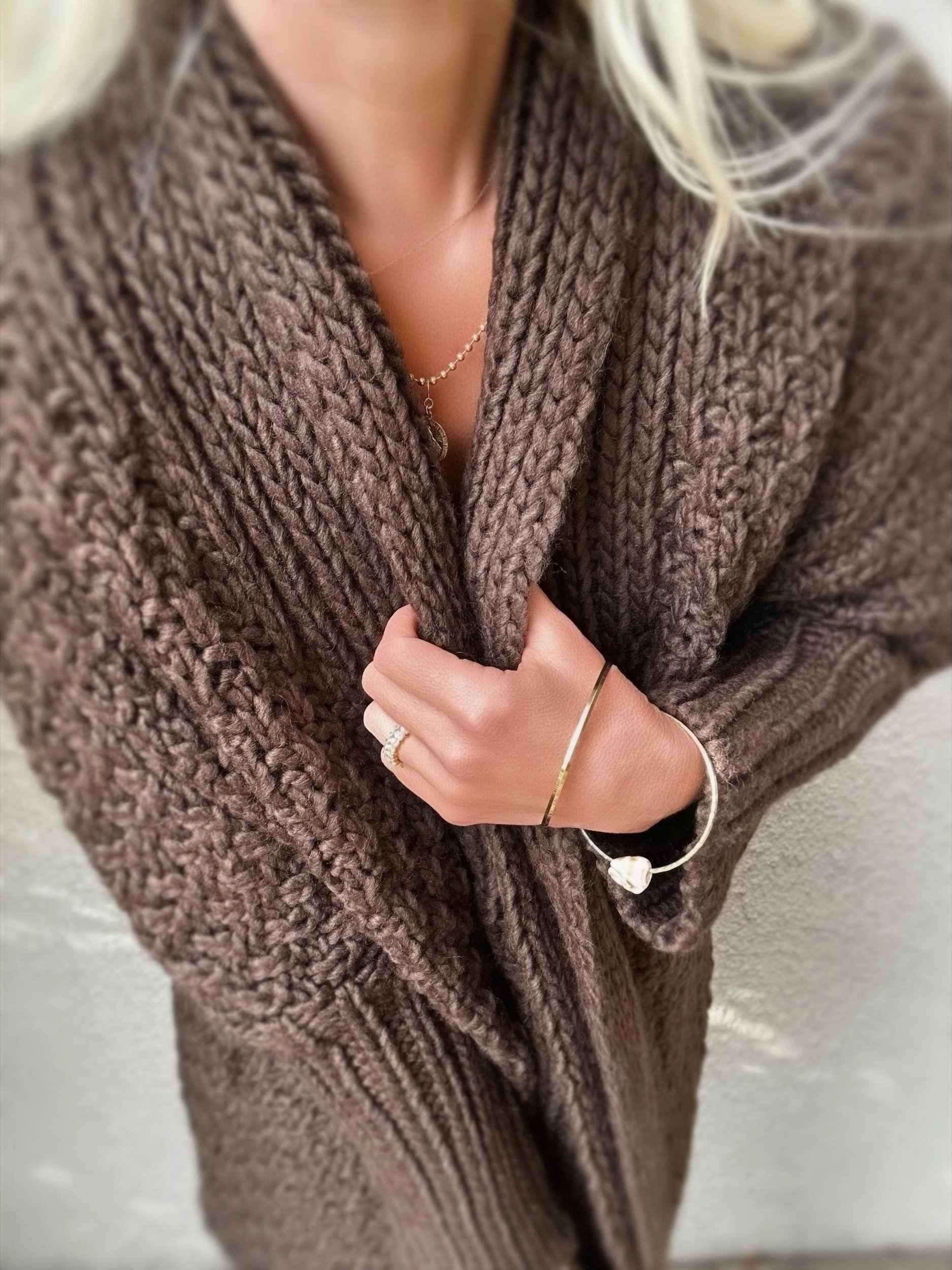 Woman wearing the brown Banditas Honolua Long Cardigan showing its open front and relaxed drape
