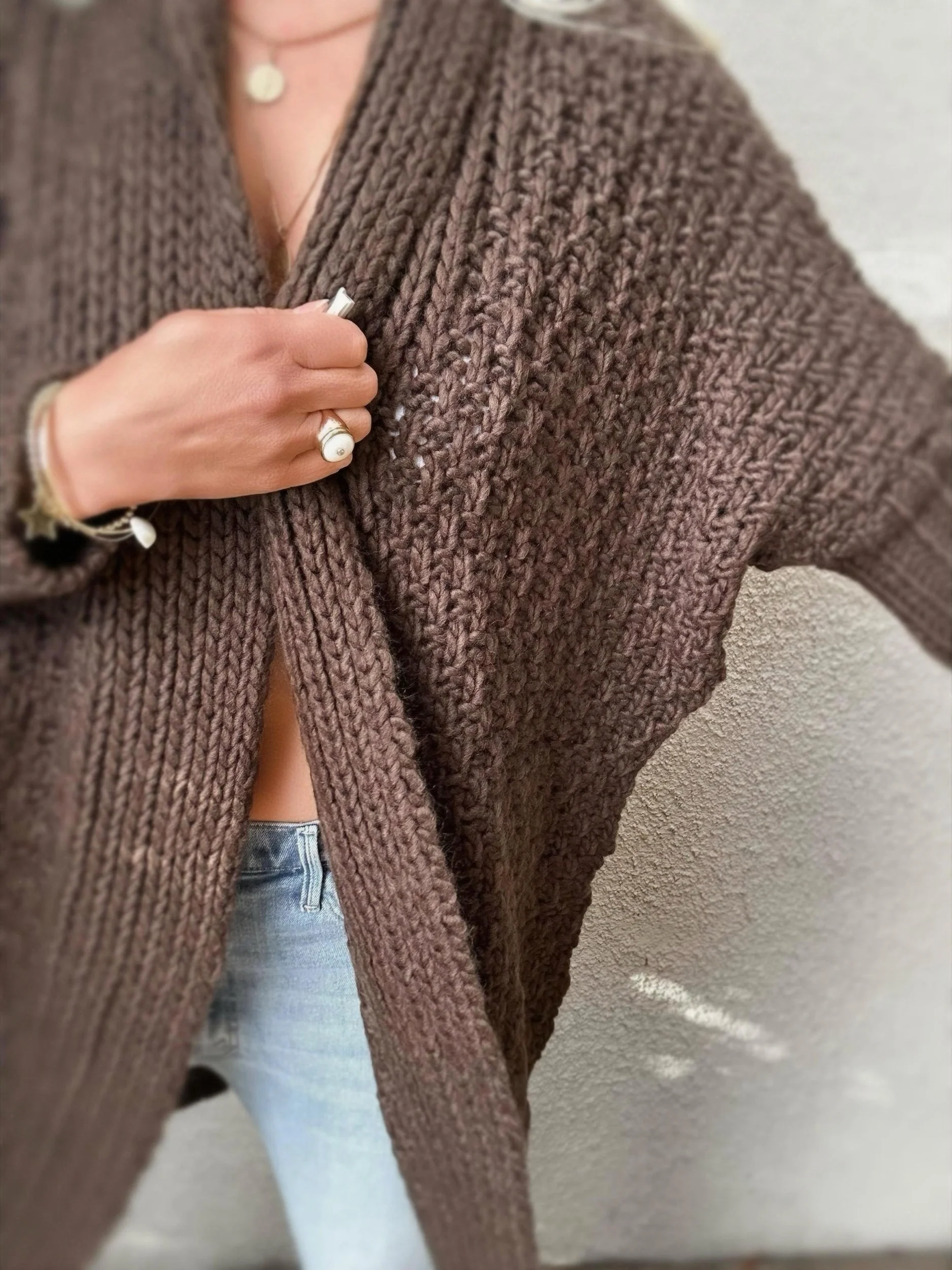 Woman wearing the brown Banditas Honolua Long Cardigan with jeans, showing its relaxed fit and wide sleeves