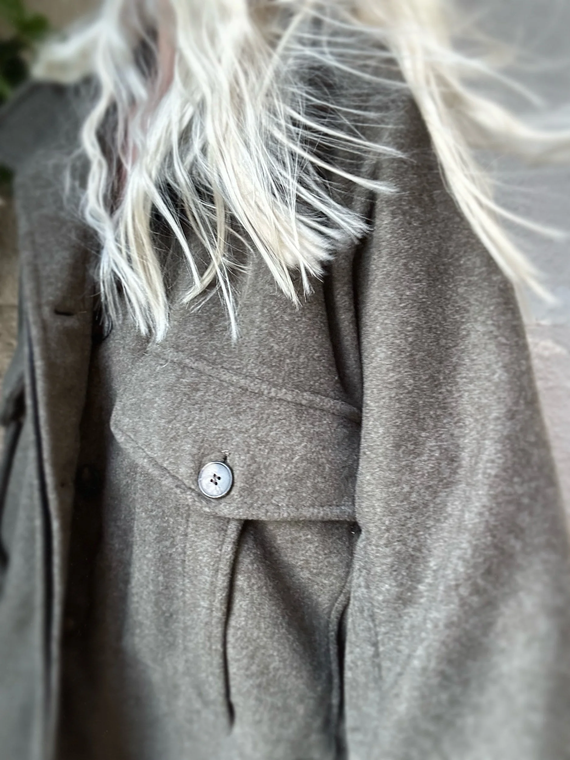 Woman wearing the khaki Banditas Kapalua Jacket showing its oversized fit and buttoned front pockets