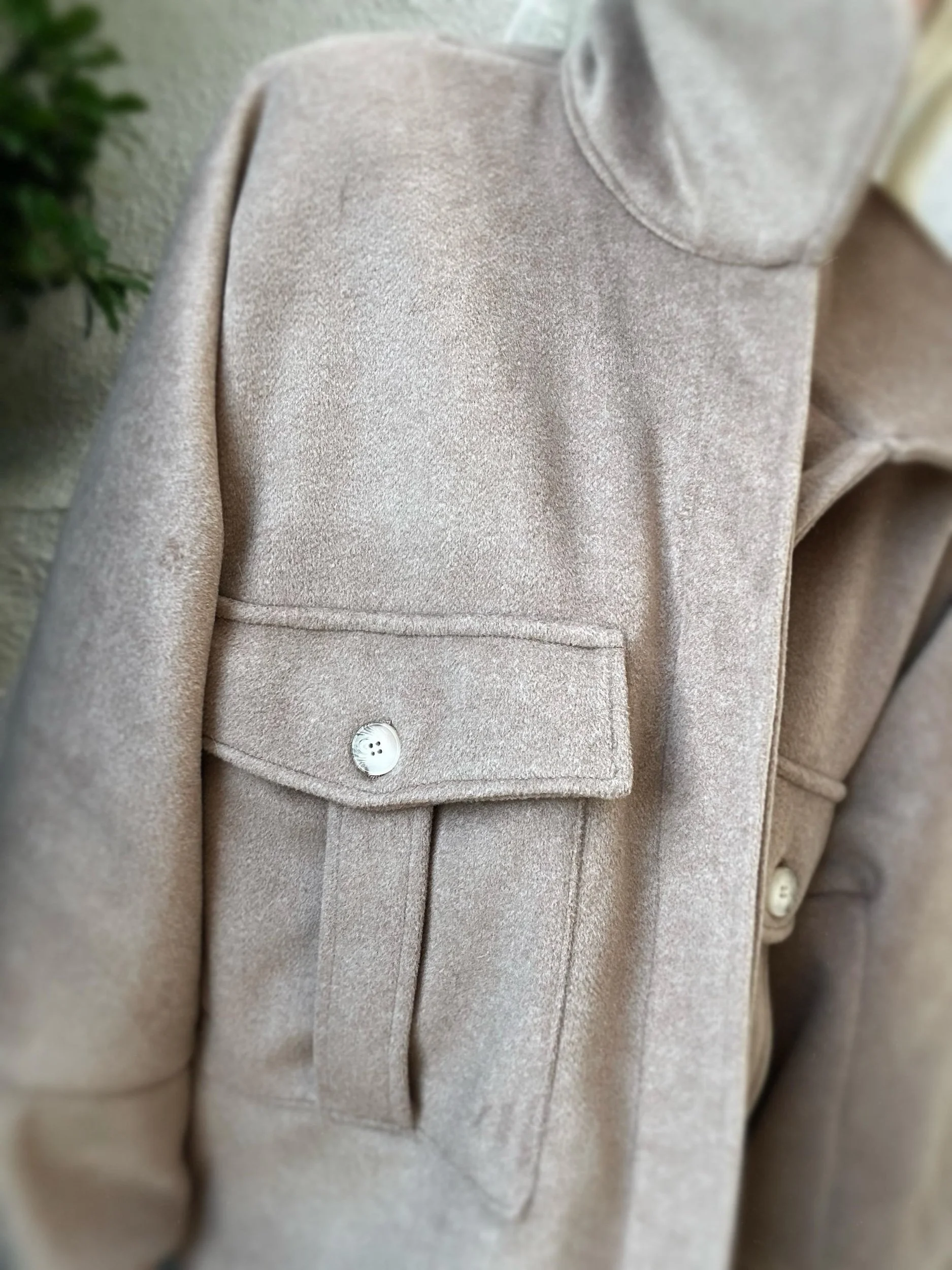 Close-up of taupe Banditas Kapalua Jacket showing front flap pocket, button and soft texture