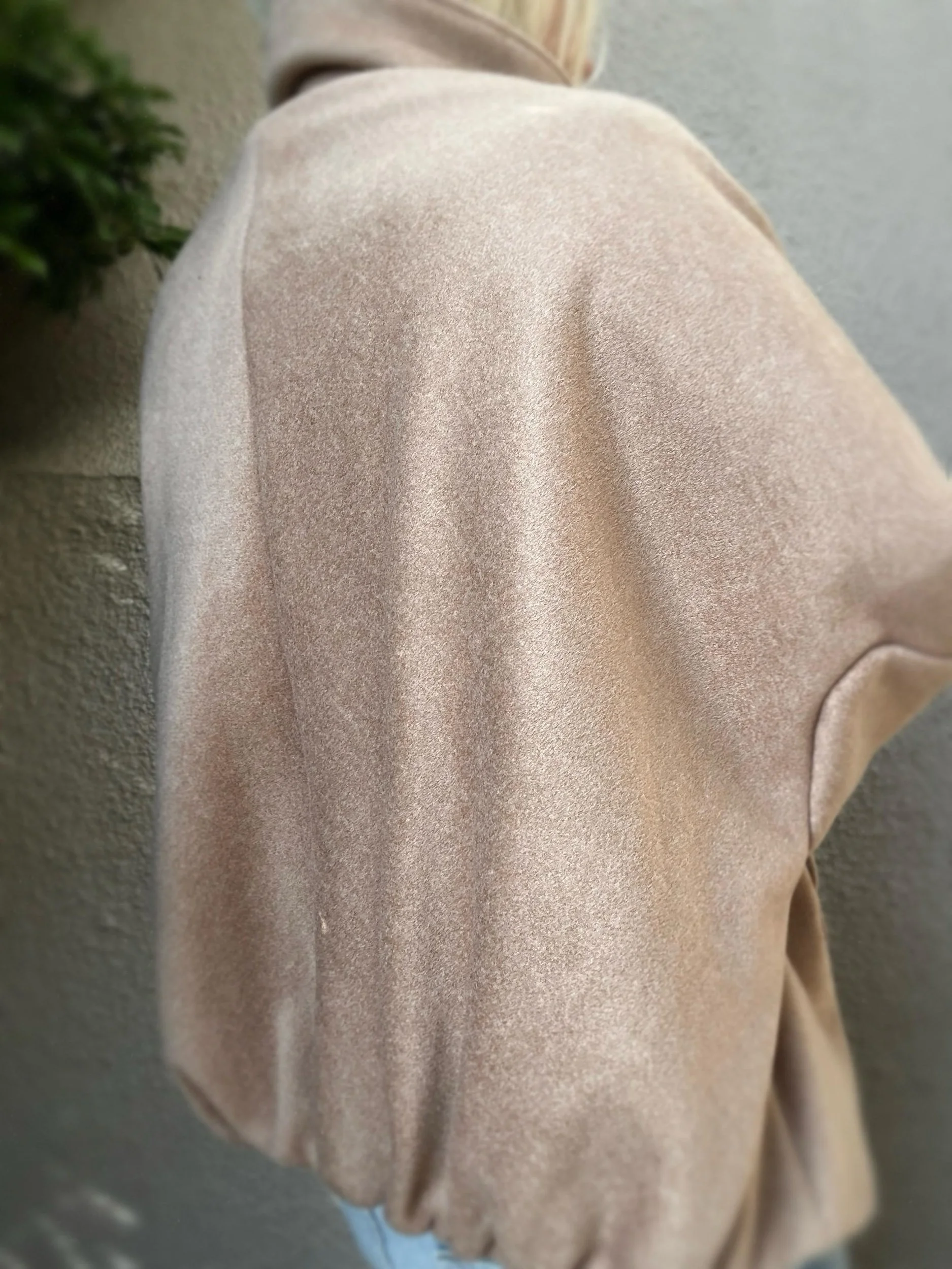 Side view of taupe Banditas Kapalua Jacket showing its relaxed silhouette and textured fabric