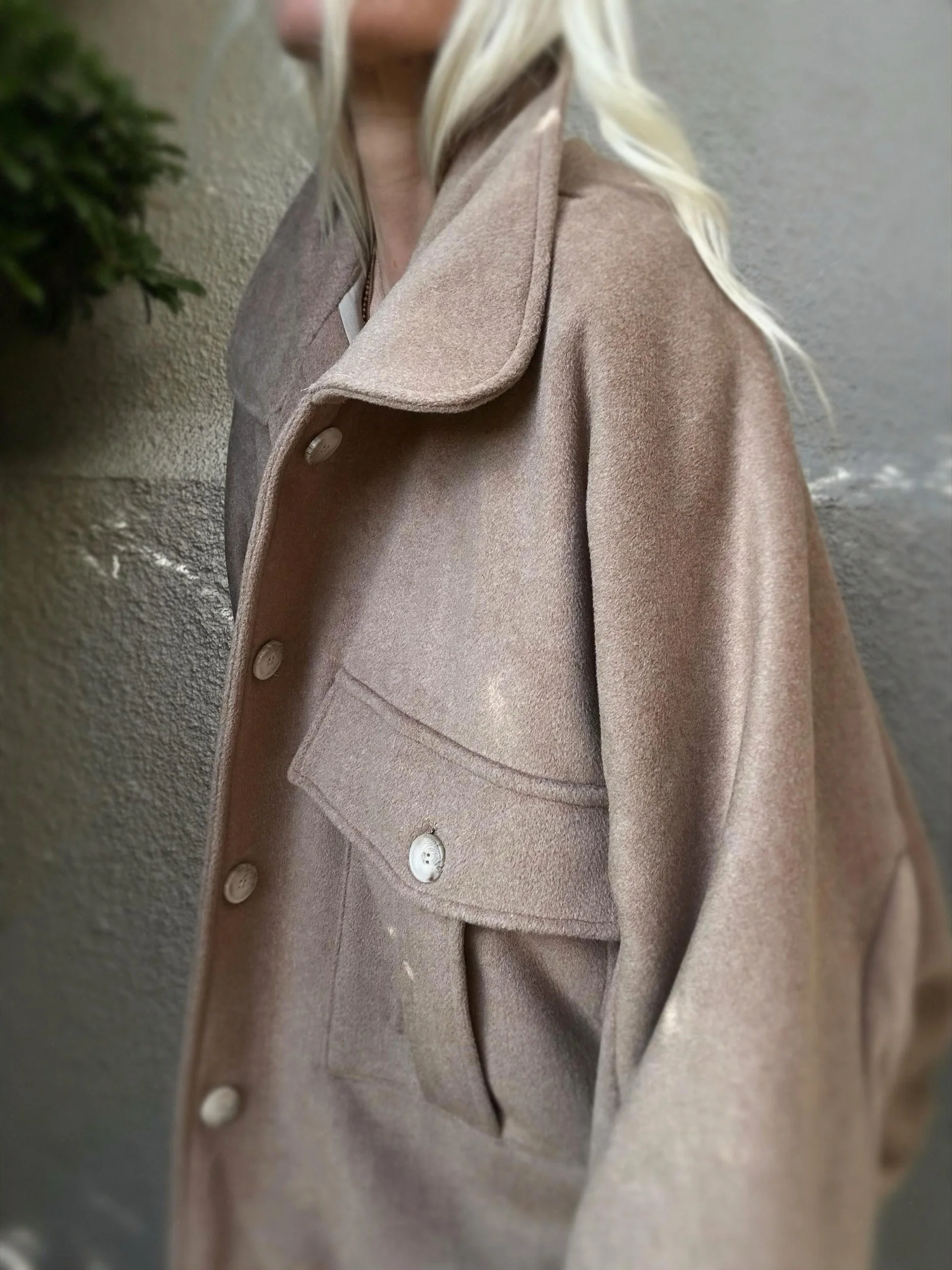 Side view of taupe Banditas Kapalua Jacket showing its statement collar and front pocket