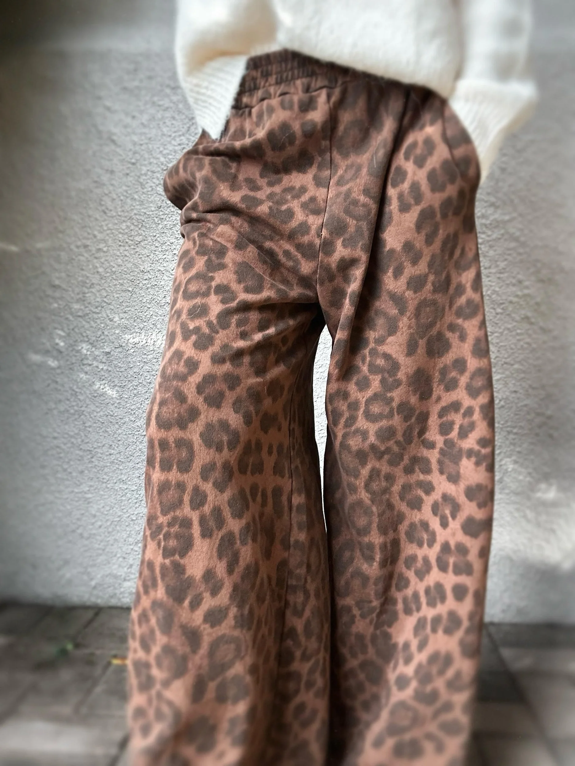 Close-up of Banditas Keanae Joggers highlighting the brown leopard print, elastic waistband and loose fit