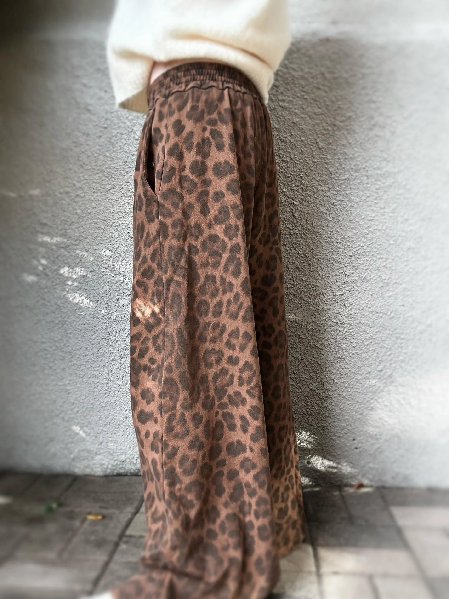 Side view of Banditas Keanae Wide-Leg Joggers showing the flowing wide-leg silhouette and leopard print