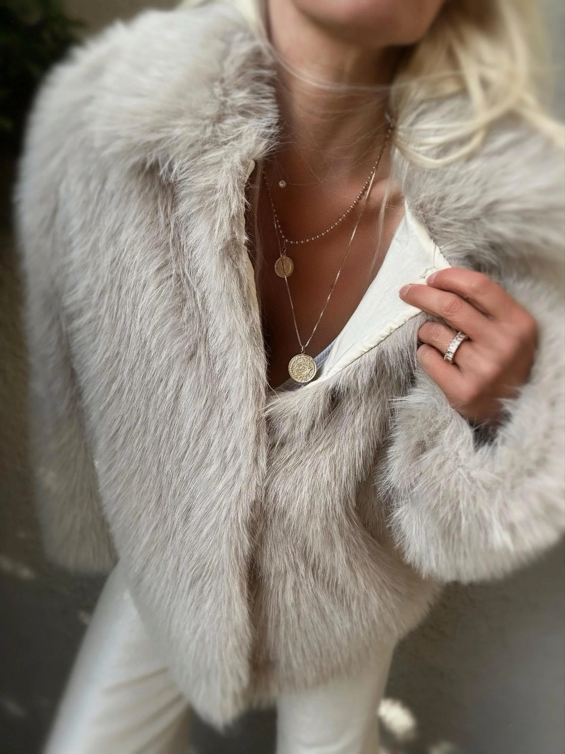 Close-up of cream Banditas Makena Faux Fur Jacket showing its soft oversized collar and open front