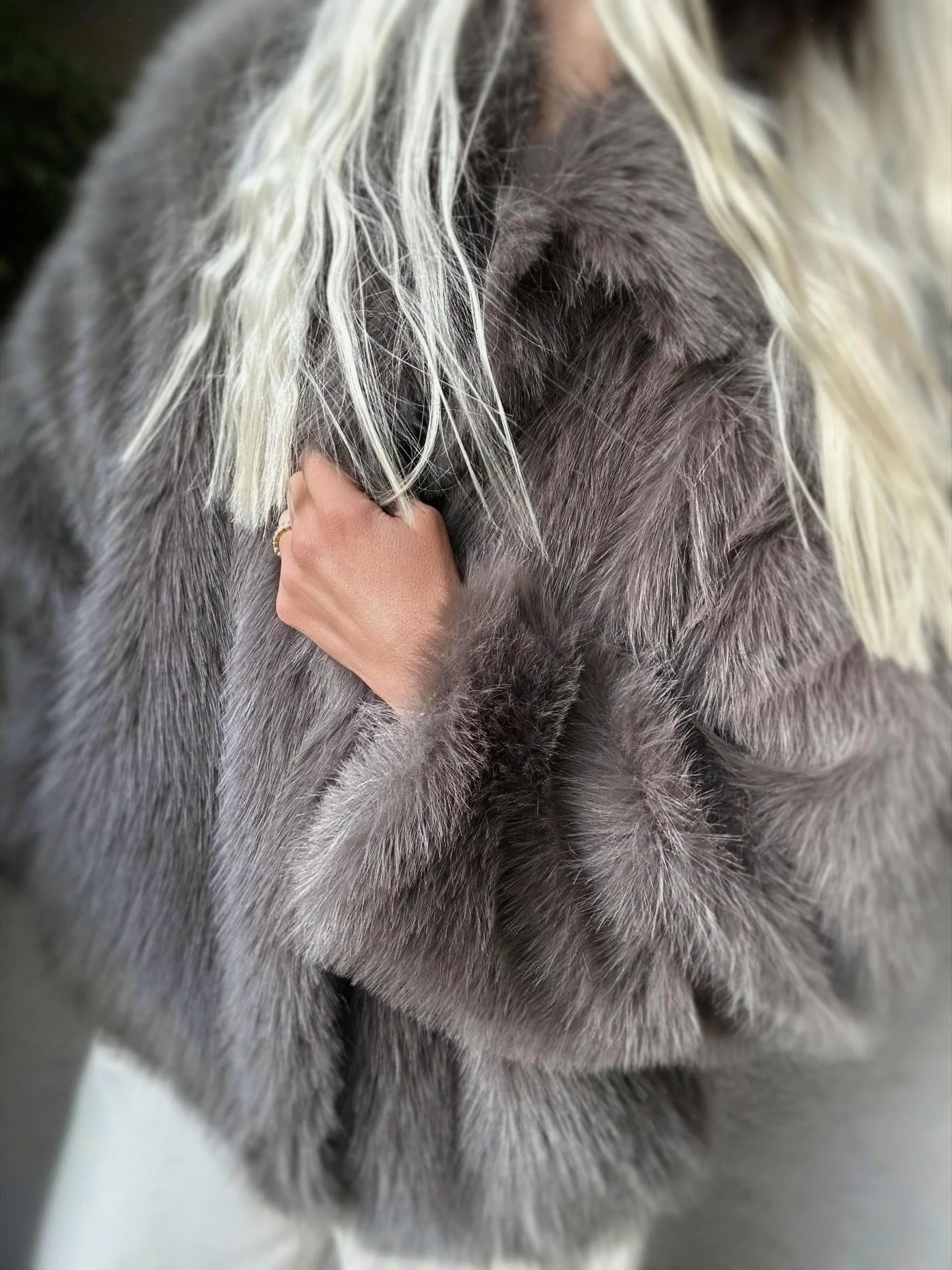 Woman wearing the dark brown Banditas Makena Faux Fur Jacket with plush collar and textured sleeves