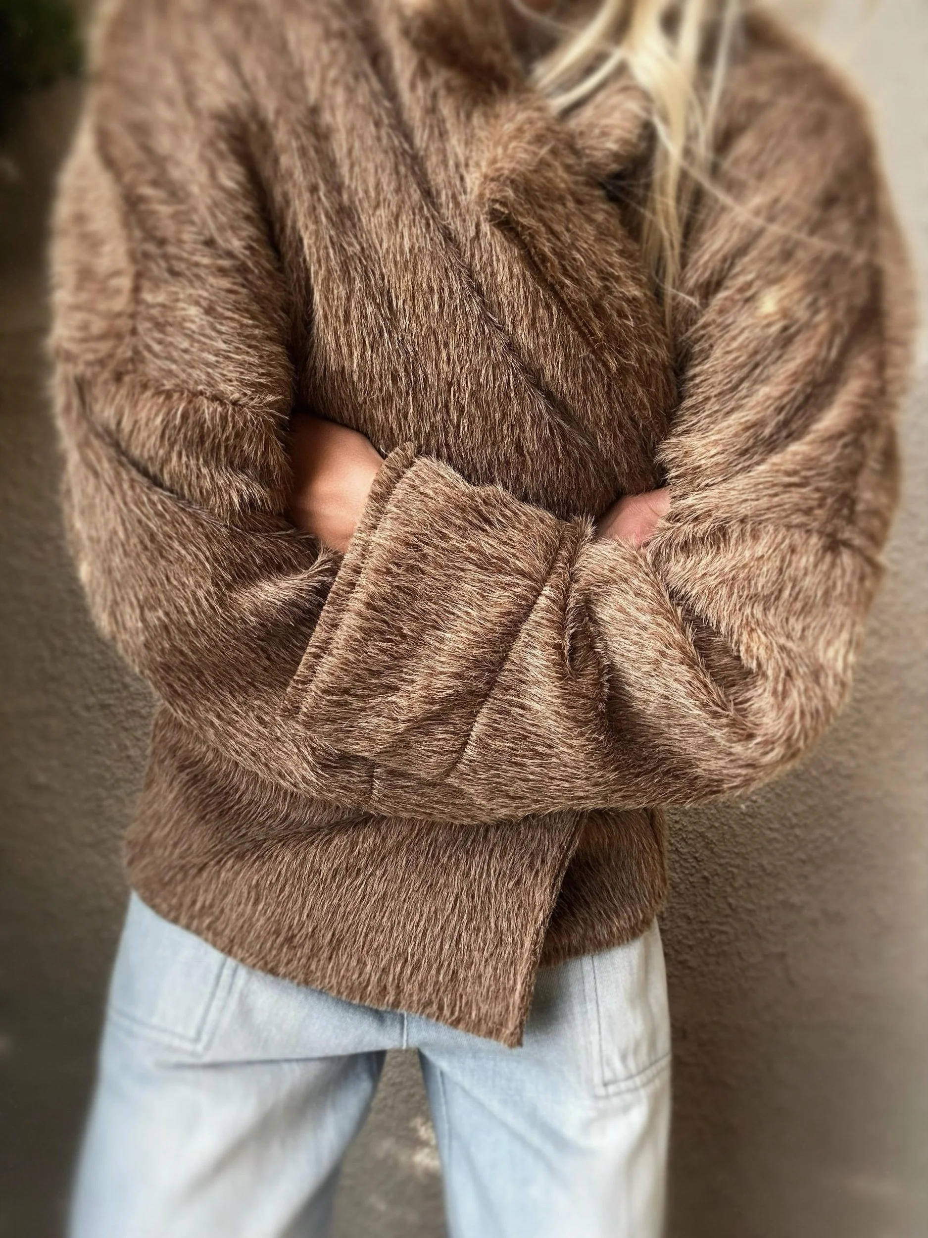 Woman wearing the brown Banditas Napili LOVE Jacket showing its relaxed fit and soft, fuzzy sleeves
