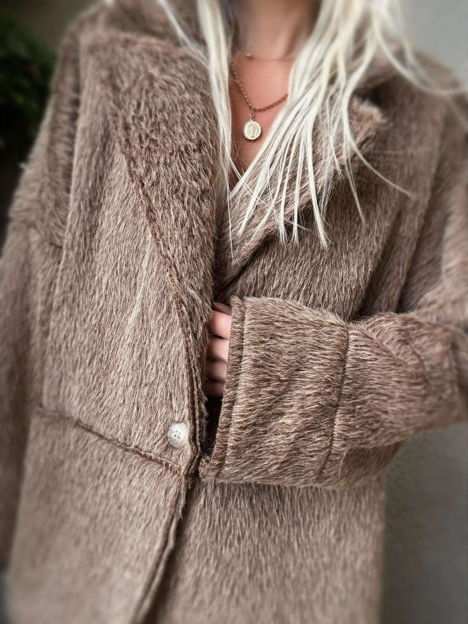 Woman wearing the brown Banditas Napili LOVE Jacket showing its front closure and cozy texture