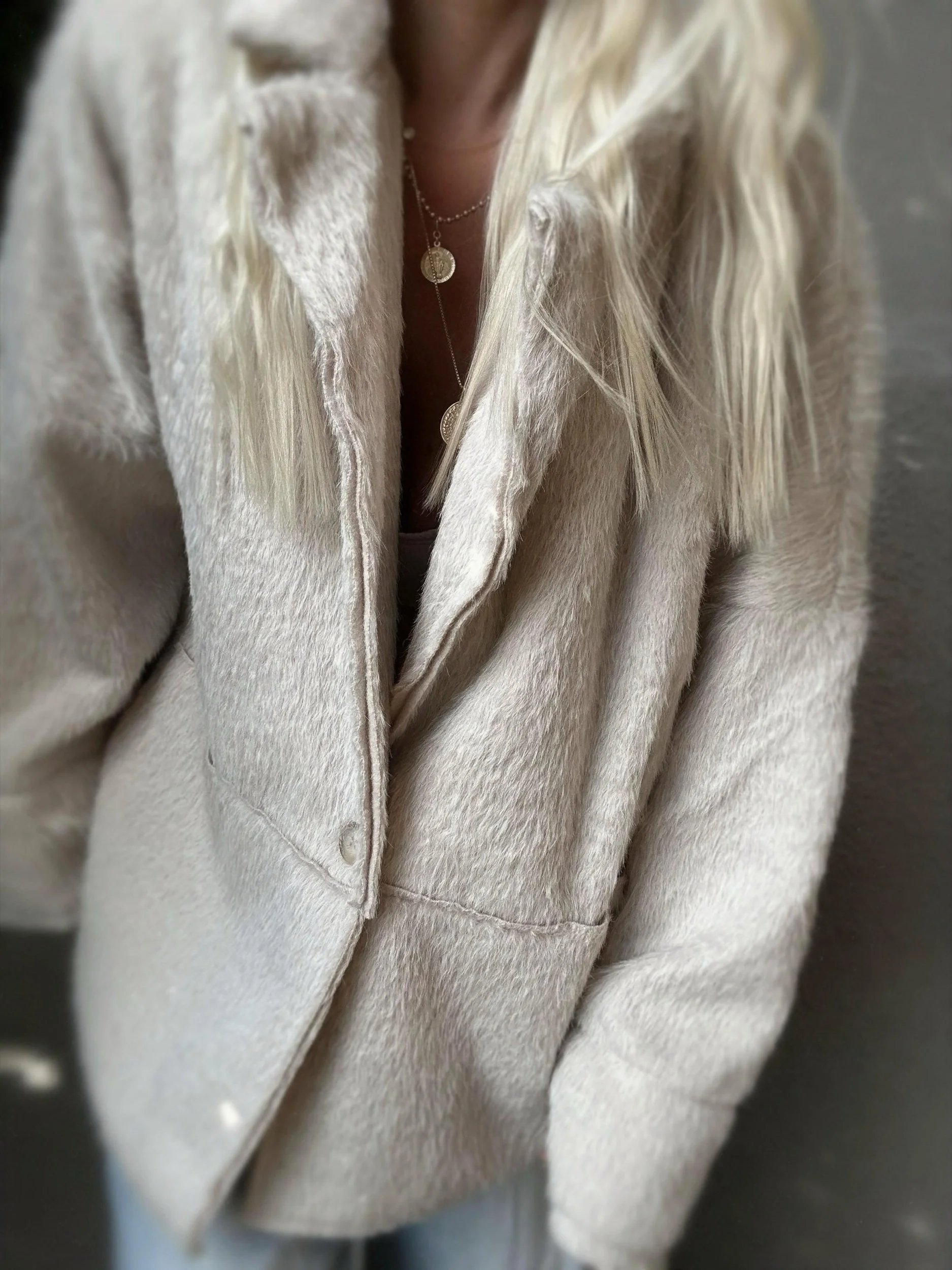 Close-up of cream Banditas Napili LOVE Jacket showing its soft texture and front opening