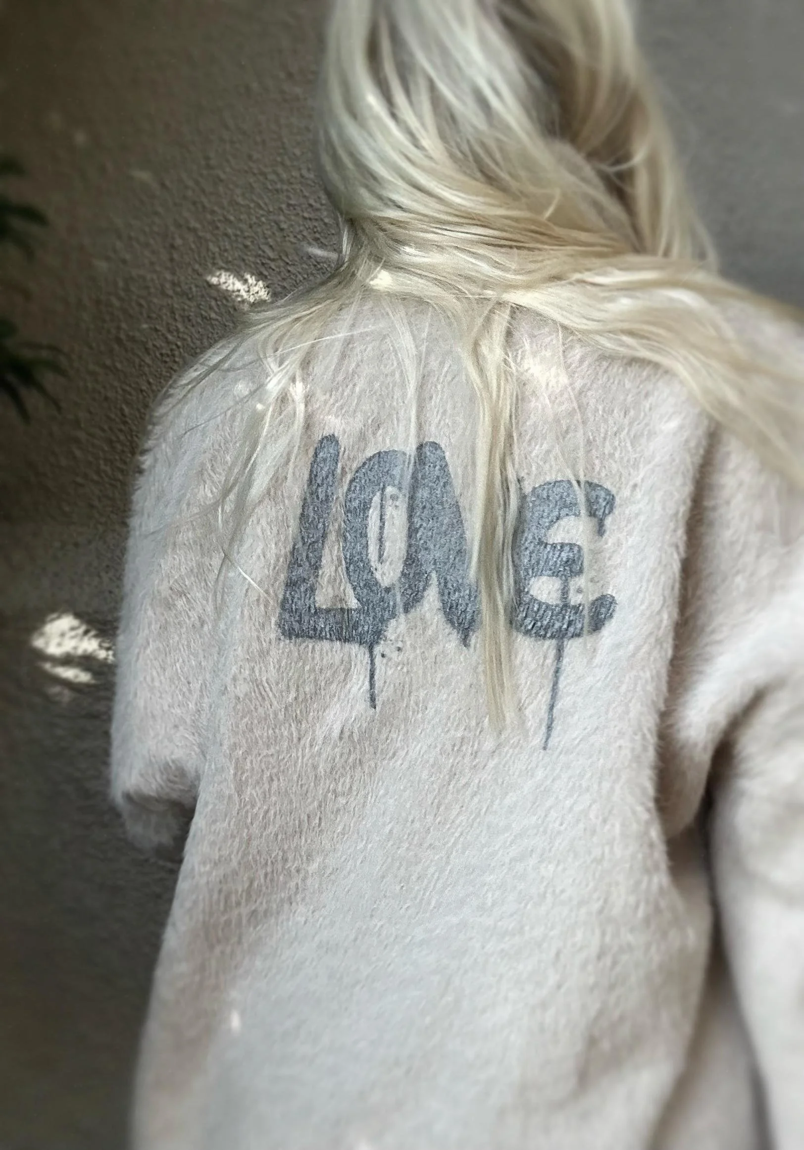 Back view of cream Banditas Napili LOVE Jacket featuring grey LOVE lettering