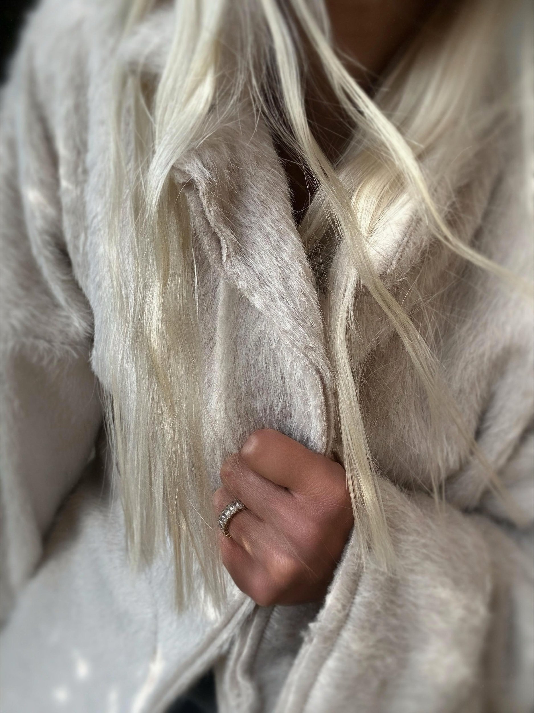 Close-up of cream Banditas Napili LOVE Jacket showing its fuzzy texture and open neckline