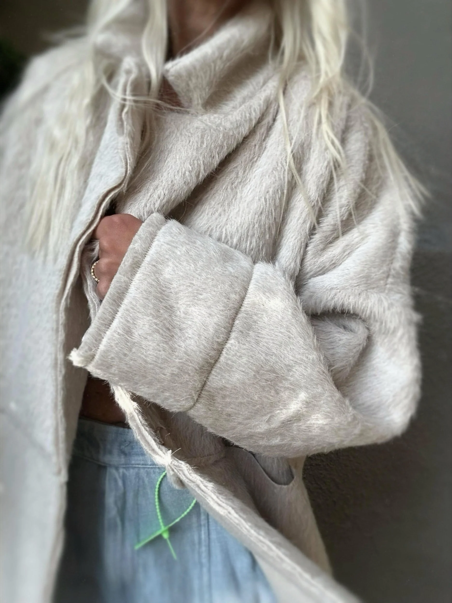 Side view of cream Banditas Napili LOVE Jacket showing its oversized sleeves and relaxed shape