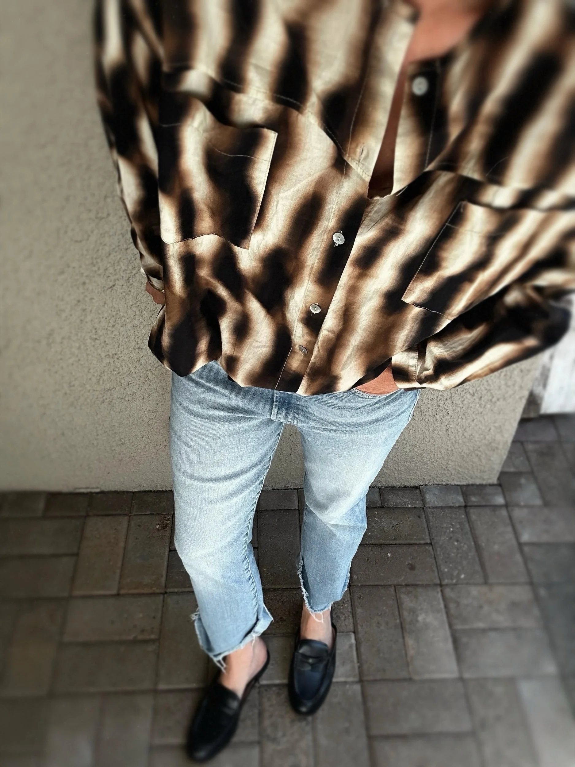 Lower view of Banditas Olowalu Blouse worn loose over distressed blue jeans