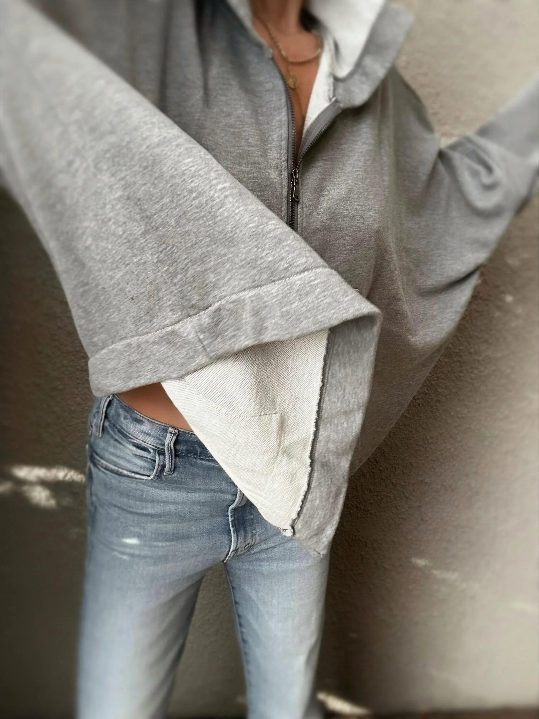 Close-up of the grey Banditas Paradise sweatshirt sleeve showing its wide cuff and textured fabric
