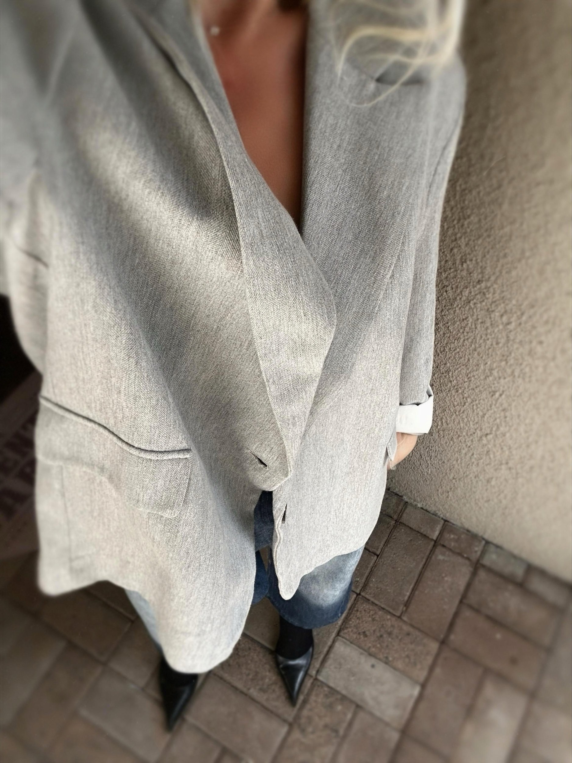 Angled view of grey Banditas Wailea Blazer showing its oversized shape, lapel collar and front pocket