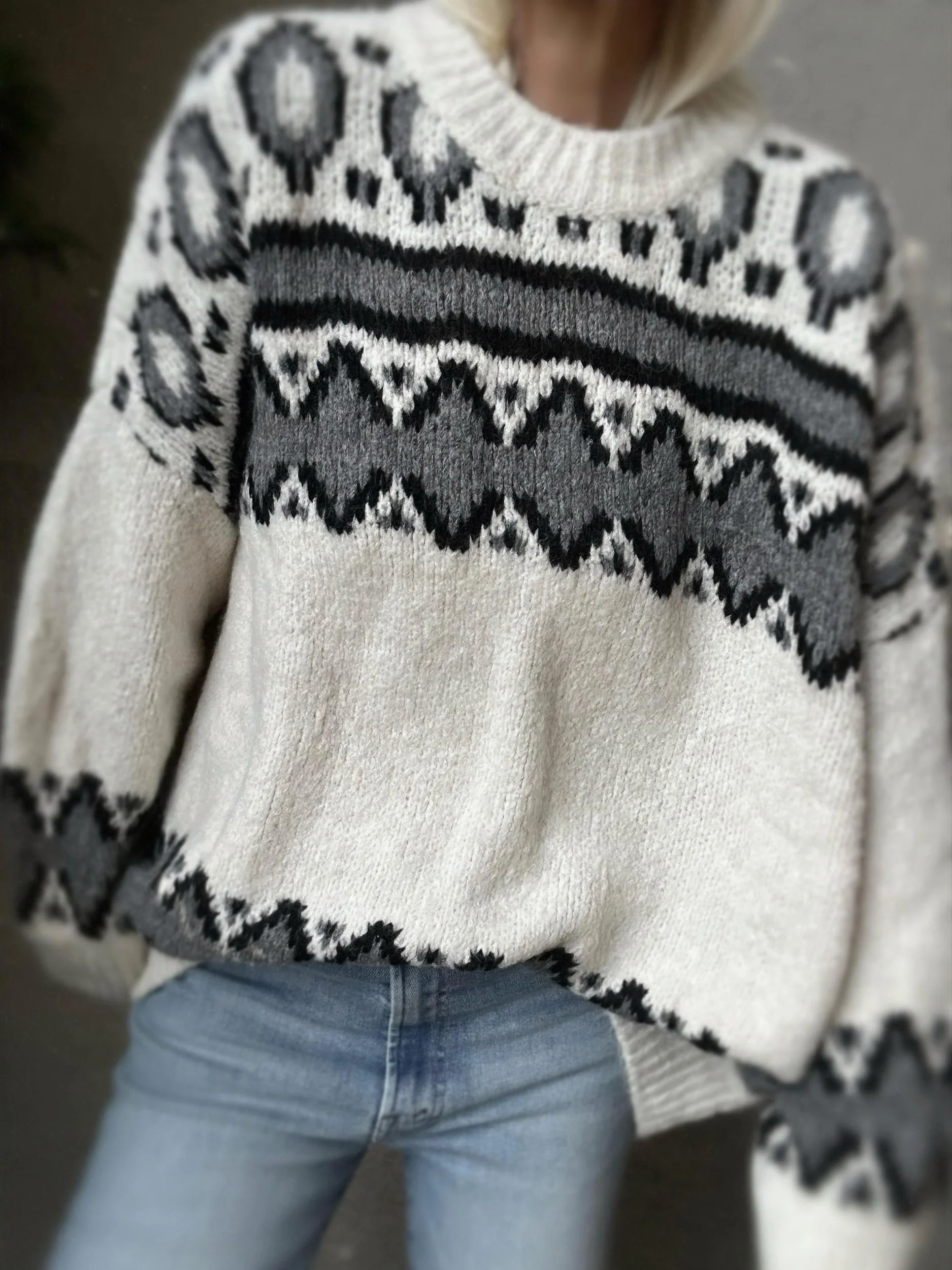 Close up of the Coastal Thread Makawao Sweater cream with black worn with jeans