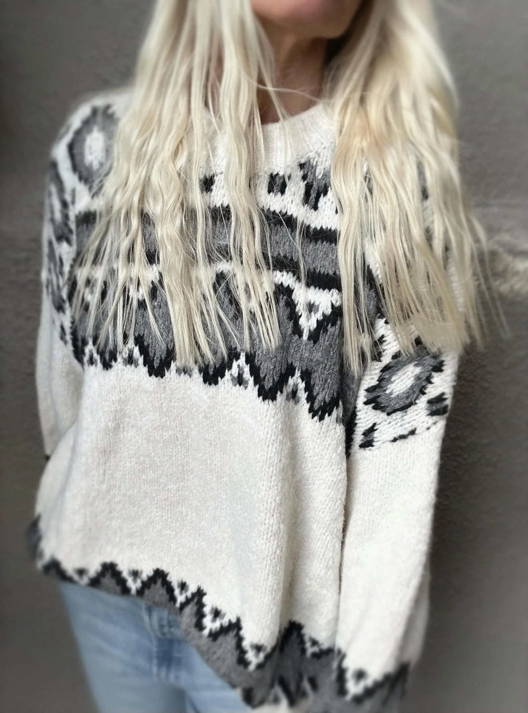 Front detail of the cream and black Coastal Thread Makawao Sweater worn with light jeans