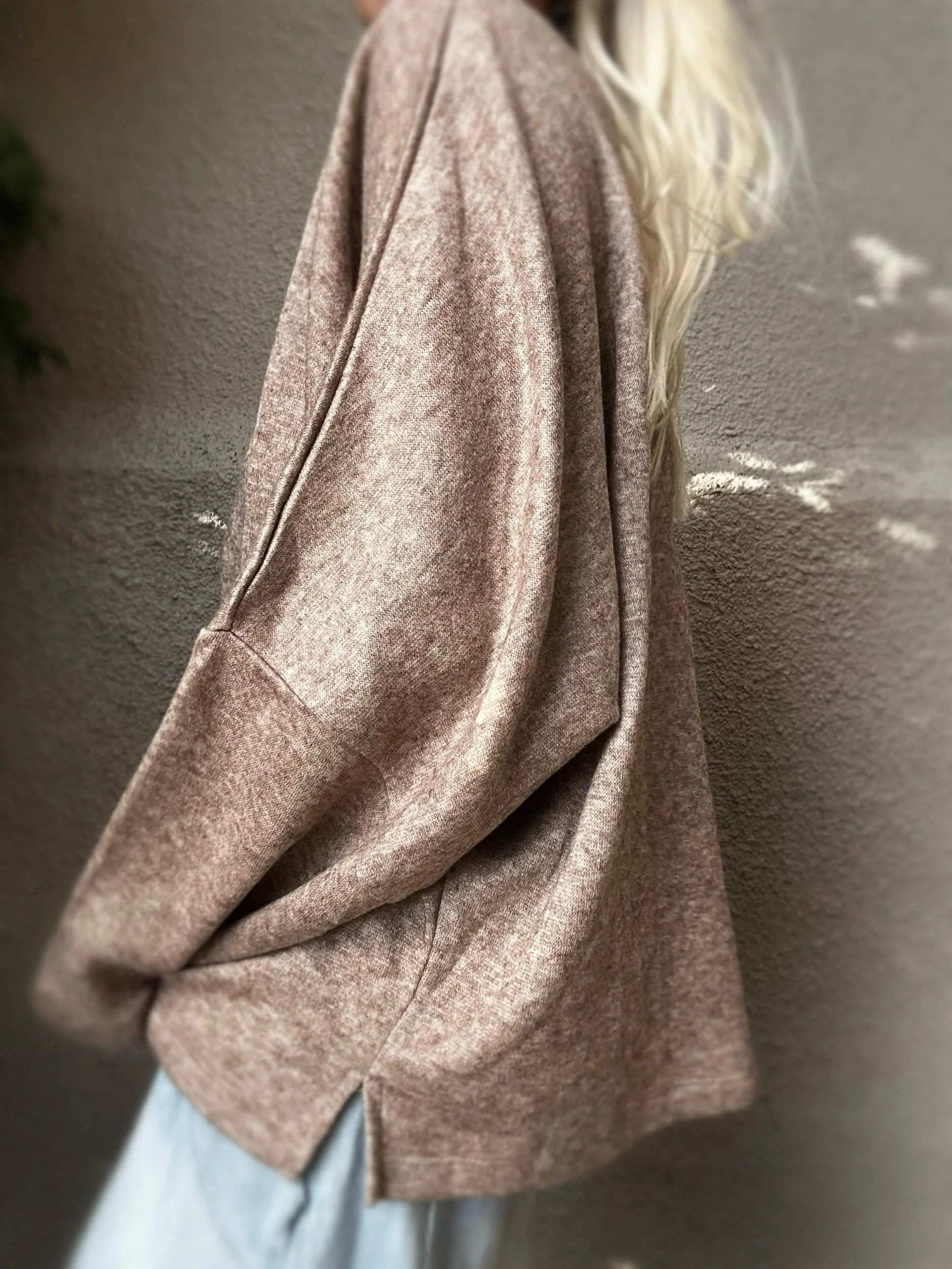 Side view of brown Banditas Haiku V-Neck Sweatshirt showing its relaxed silhouette and draped sleeve