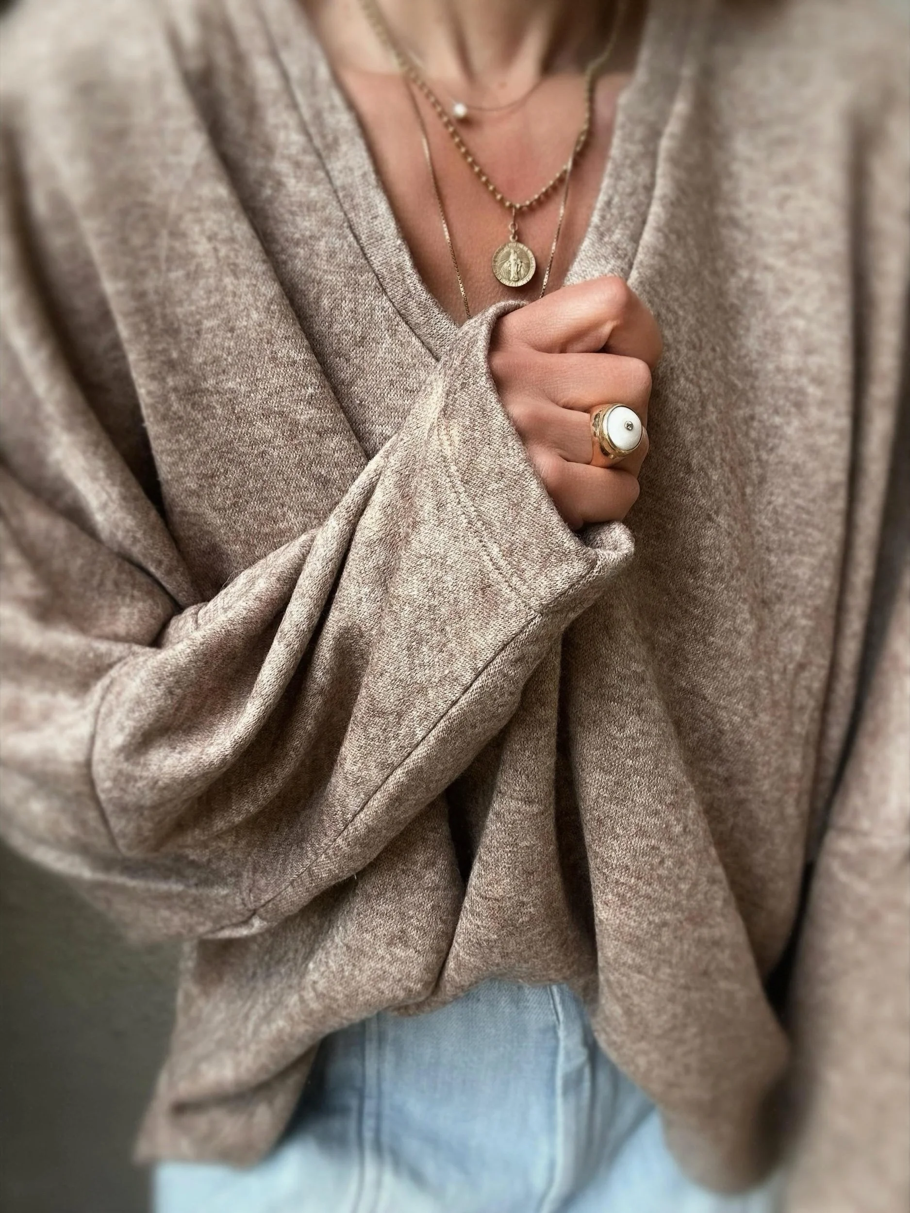 Close-up of brown Banditas Haiku Sweatshirt highlighting its loose batwing sleeve and soft texture