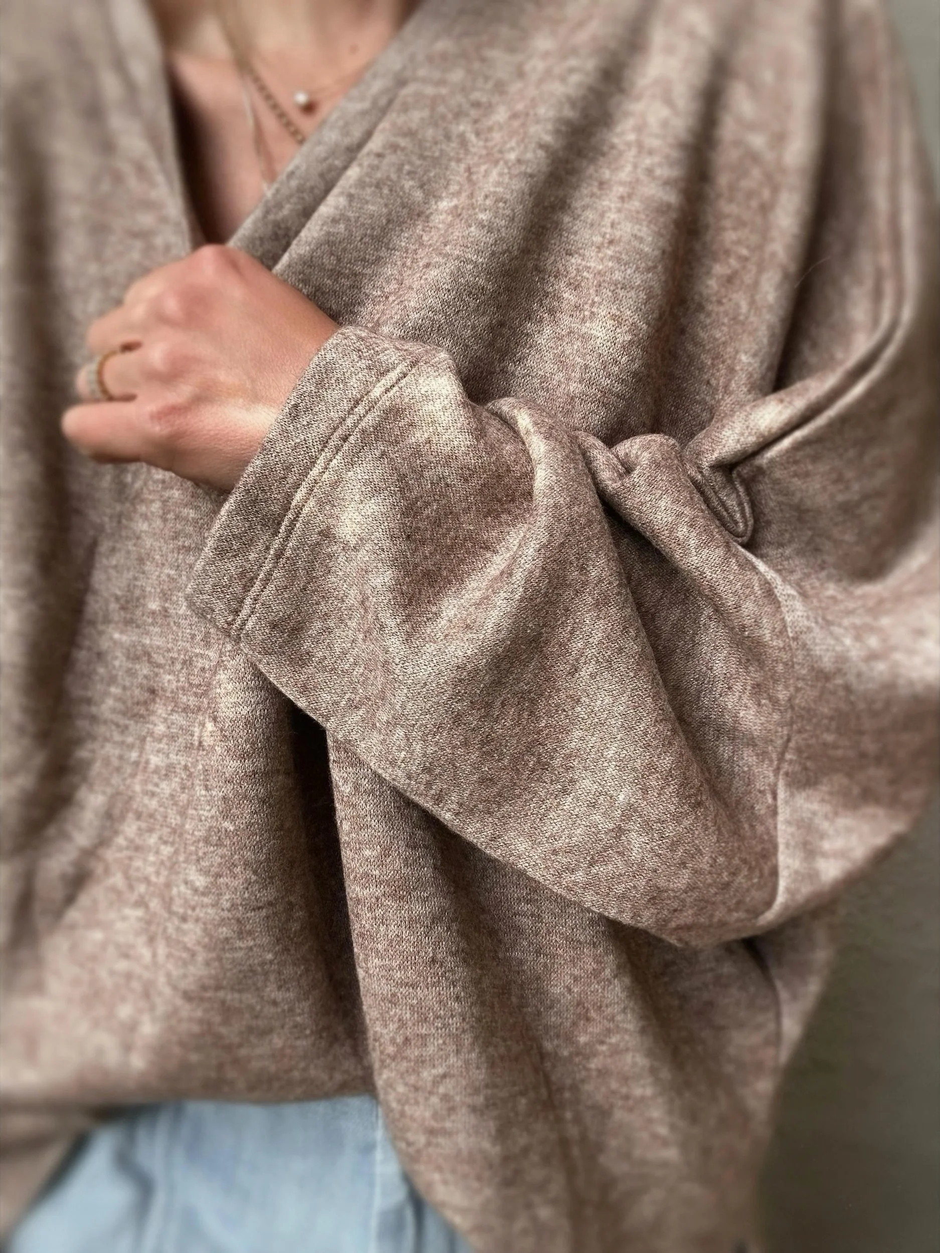 Close-up of brown Banditas Haiku Sweatshirt showing the oversized sleeve and gathered fabric