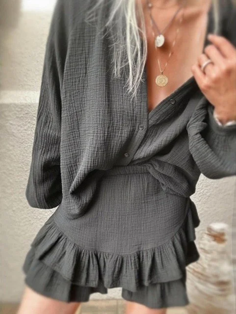 Capri Gauze Shirt in black, buttoned and tucked into the matching Capri Ruffle Skirt.