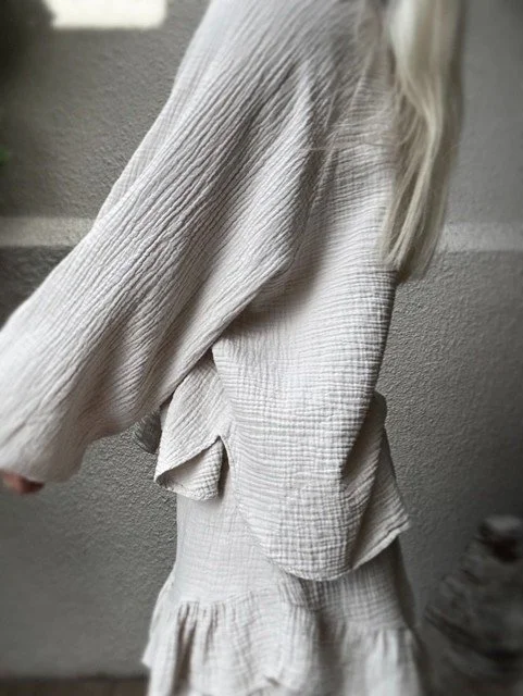 Side view of the Capri Ruffle Skirt in beige cotton gauze.
