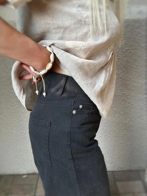 Black high-waisted jeans with flared frill hem