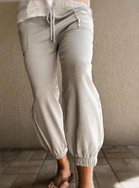 Woman wearing the Fossil Grey Waden Jogger with a relaxed fit, soft stretch cotton fabric, and effortless everyday coastal style.