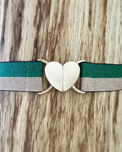 Women's green and gold heart belt styled with jeans for a coastal casual outfit