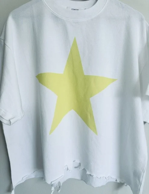 Neon Yellow Star Tee with a relaxed cropped fit and raw hem, styled for effortless everyday coastal living
