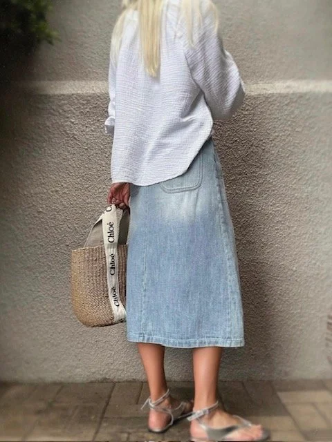 Back view of the Banditas Collatino Skirt in light-wash denim, midi length.