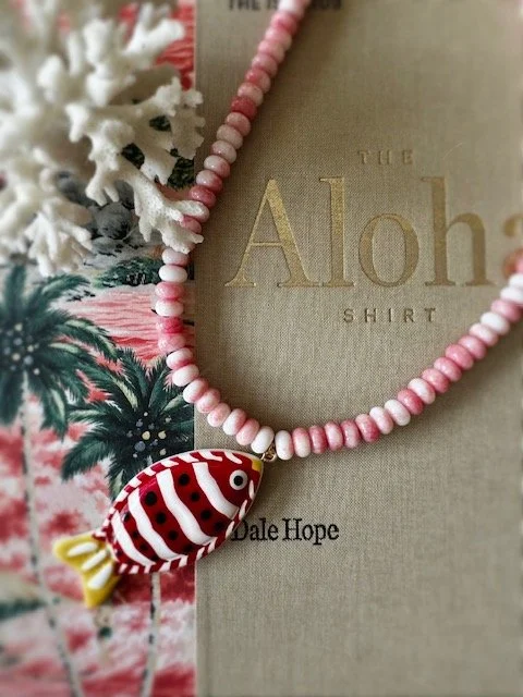 Pink and white beaded necklace with red and white fish charm