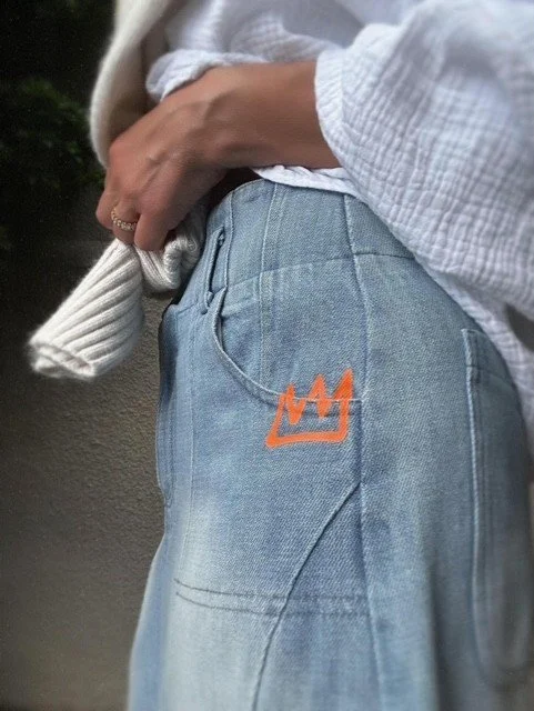 Side profile of the Collatino Skirt showing the midi length and patch pocket.
