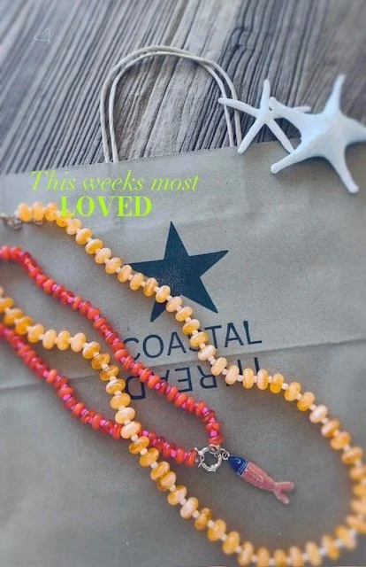 Colorful beaded fish necklaces in orange, coral and yellow