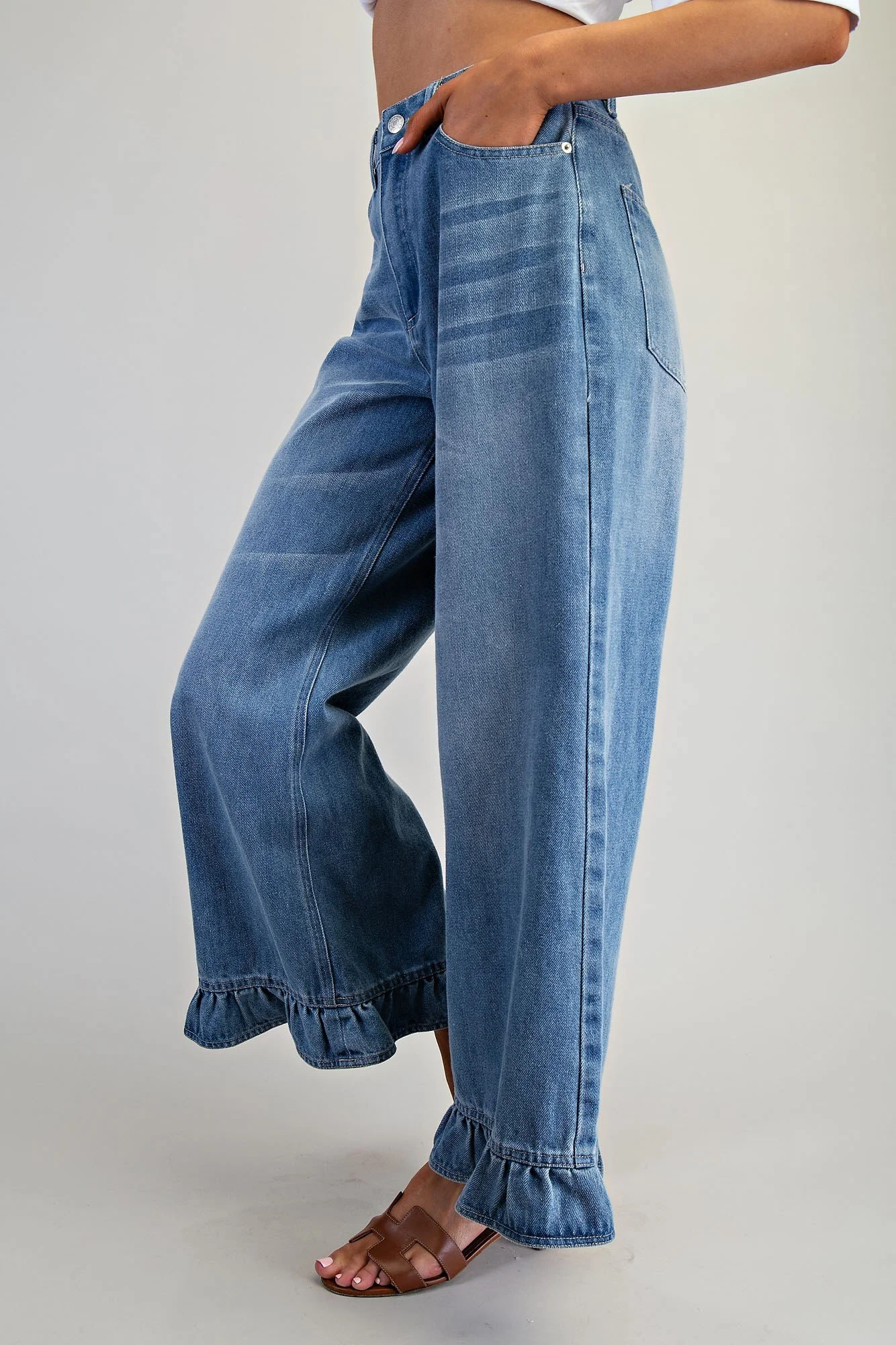Blue frill hem jeans styled with a linen blouse for a coastal look