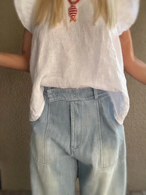 Banditas Nashi light-wash denim jeans with rolled cuffs and a relaxed white top