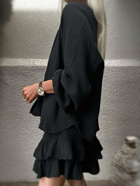 Capri two-piece look in black cotton gauze against a neutral wall.