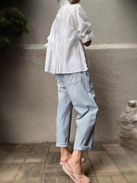 Side view of the Banditas Scornio Pants in soft blue striped cotton with relaxed barrel-leg fit and back pockets